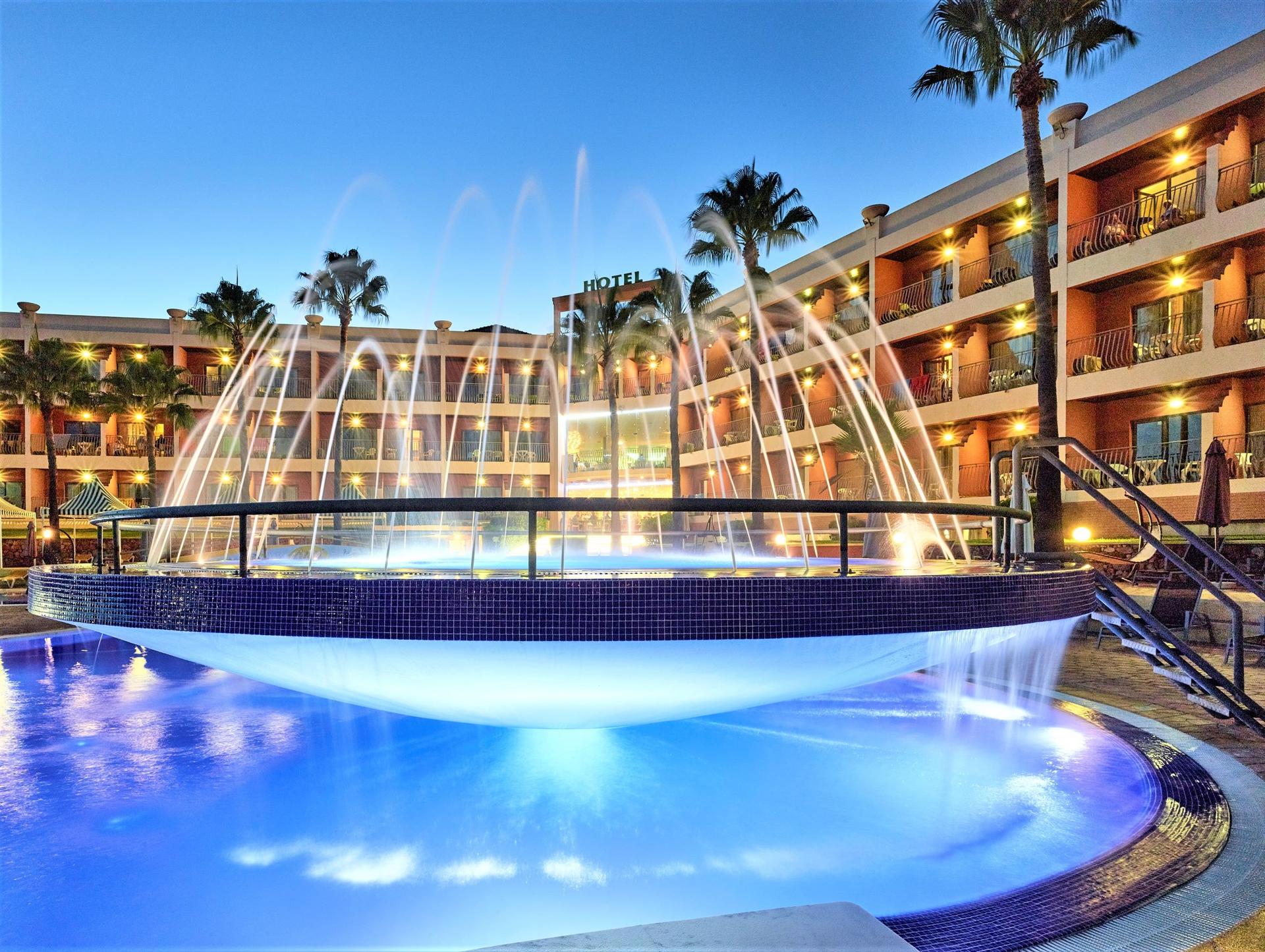 Outdoor swimming pool with a grand water fountain design