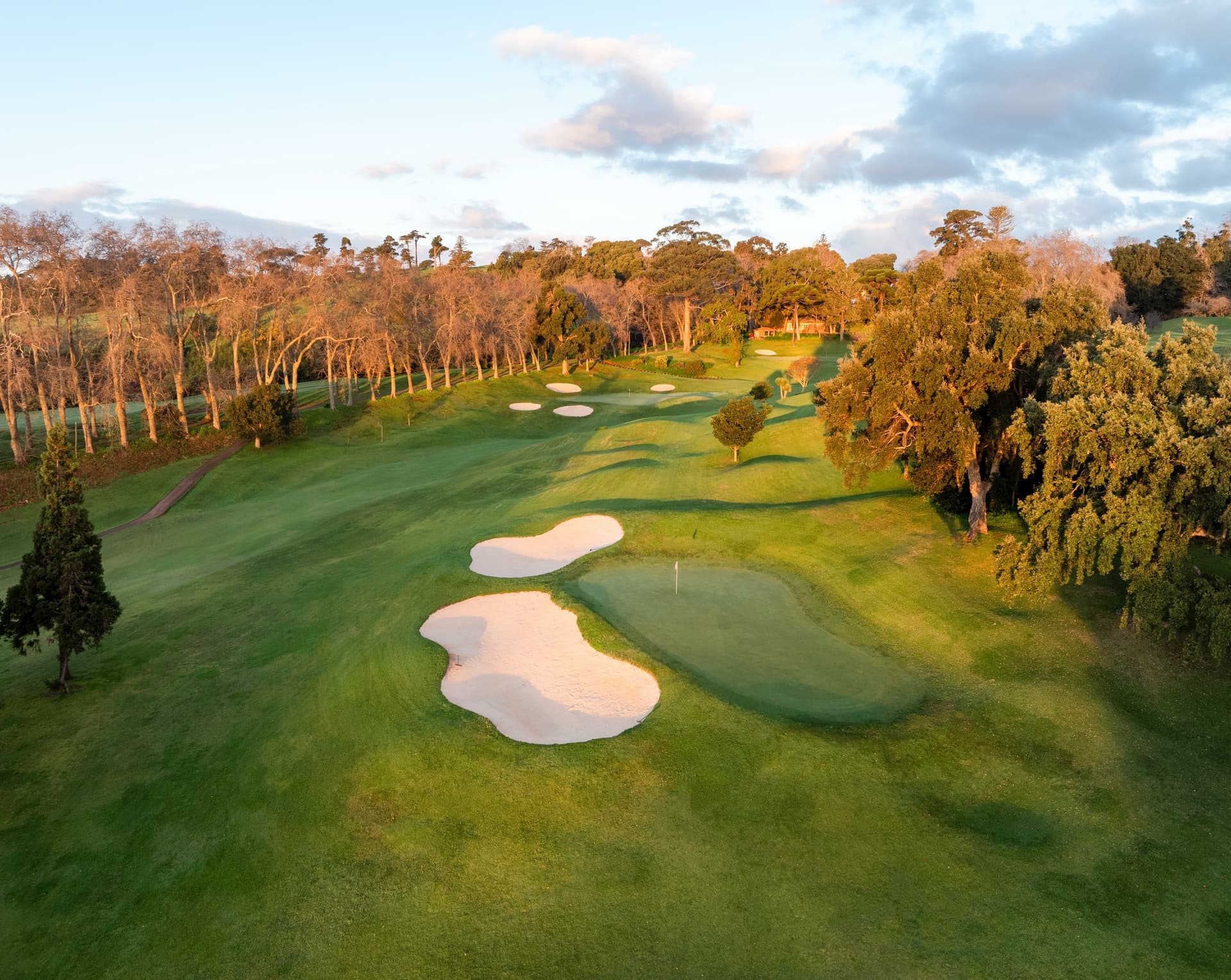 A well maintained fairway nestled with sand bunkers at Hotel Casa Velha do Palheiro - Relais & Chateaux