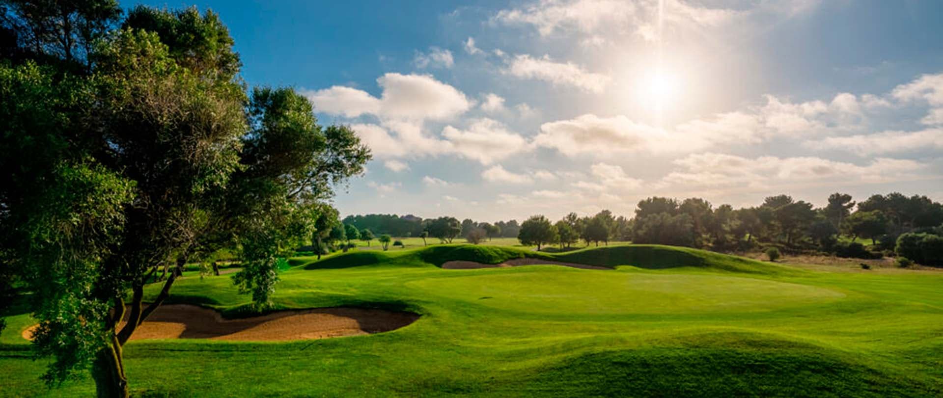 A well maintained fairway nestled with sand bunkers