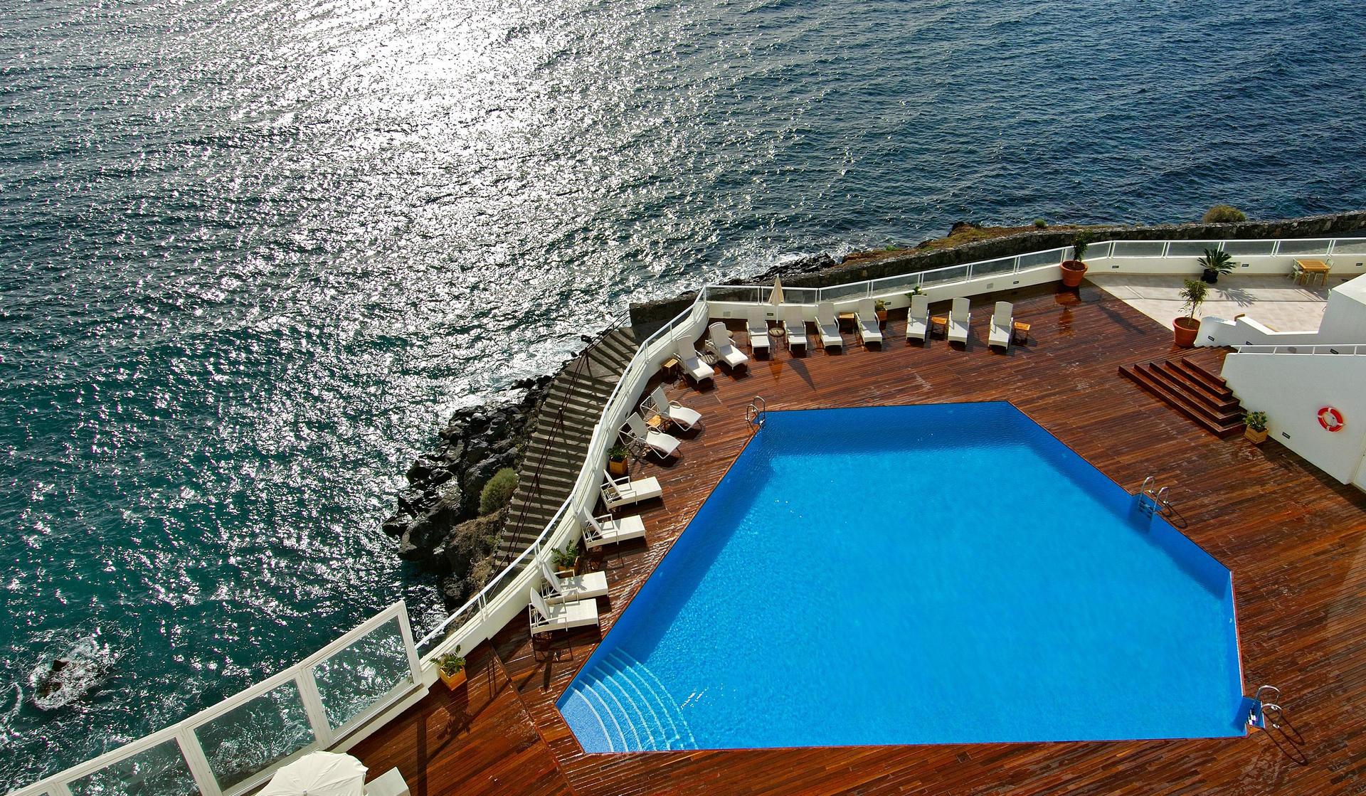 Overhead view of the outdoor swimming pol with coastal views at Hotel Tenerife Golf & Sea View