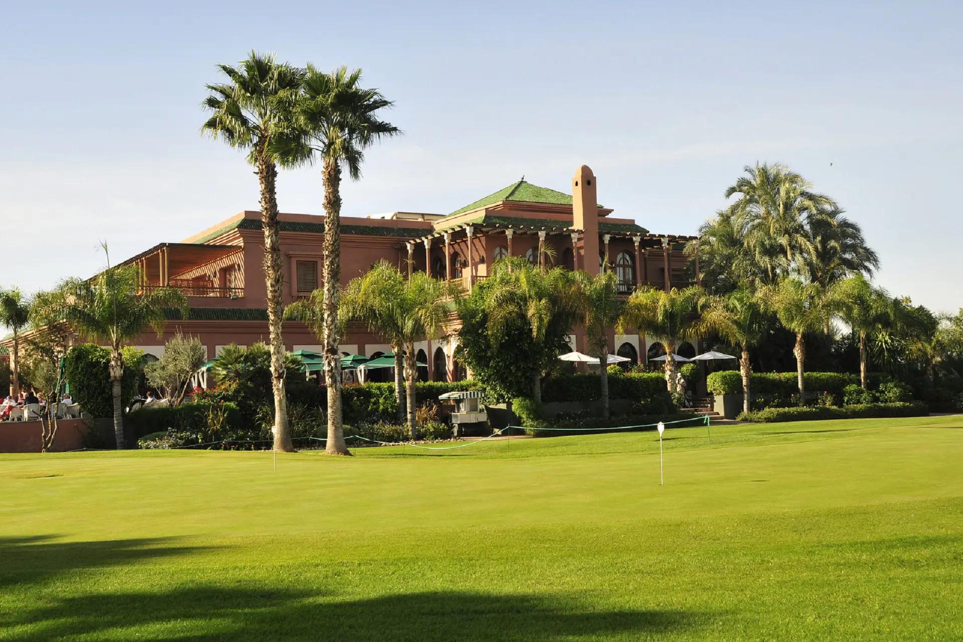 Panoramic view of a smooth green outside the Hotel du Golf by Pickalbatros building