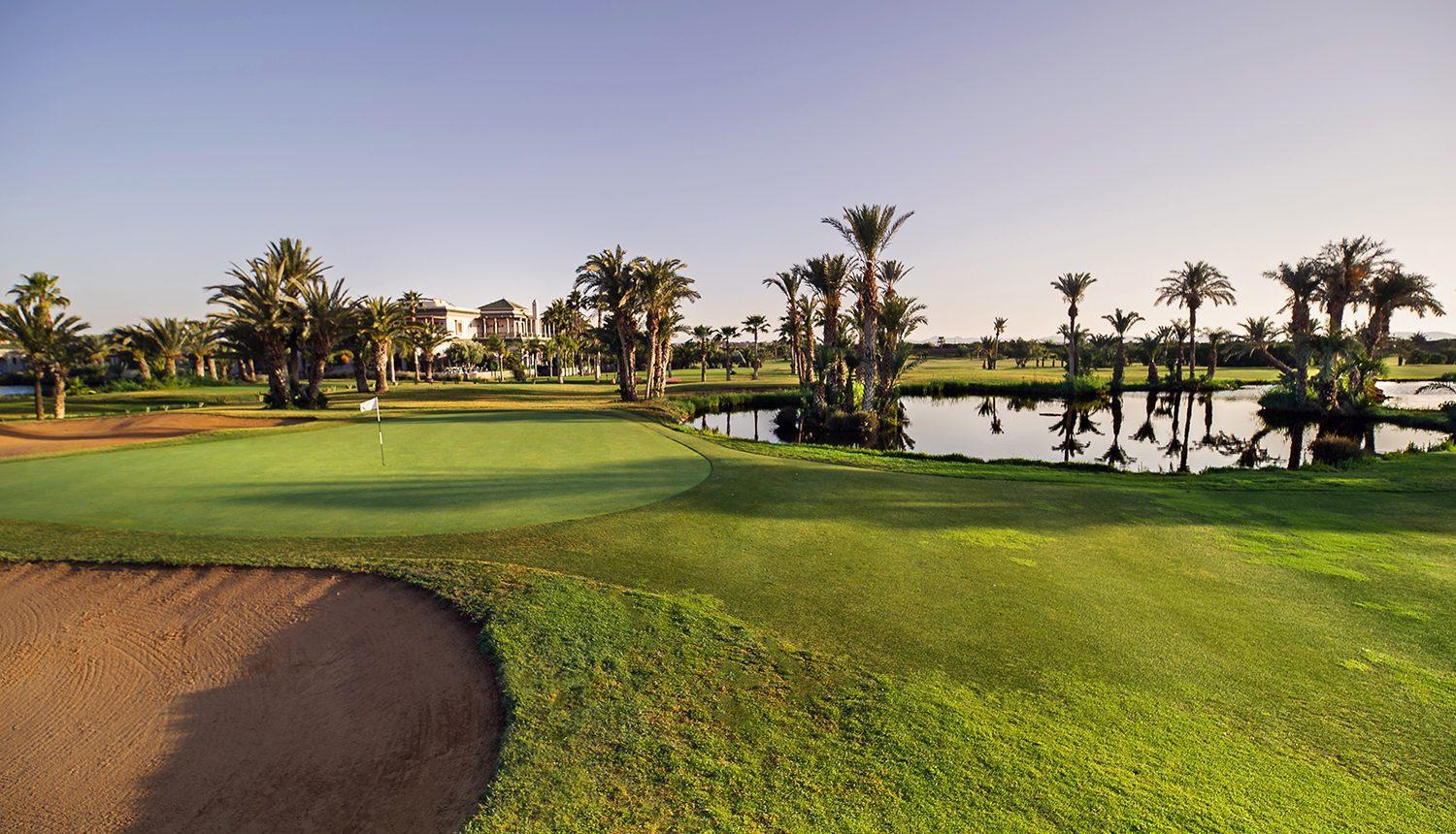 A smooth green next to a deep sand bunker at Hotel du Golf by Pickalbatros