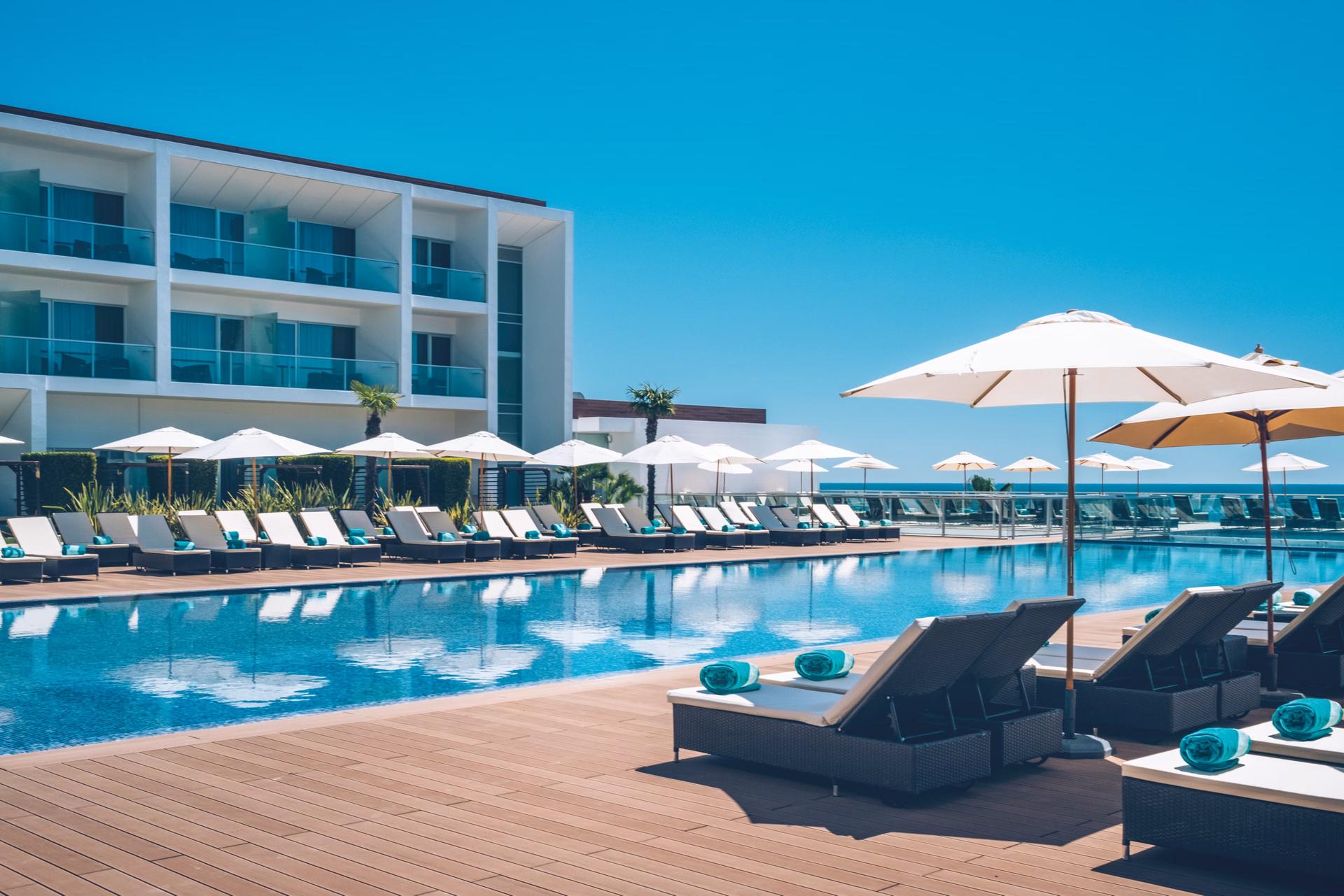 Outdoor swimming pool under clear blue skies