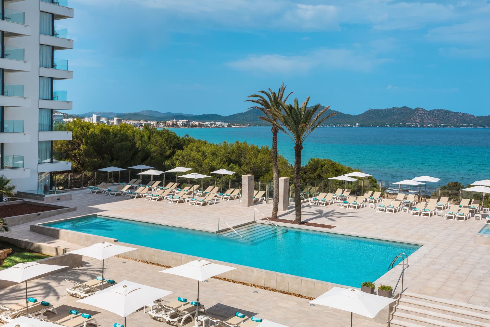 Overhead view of the outdoor swimming pool at Iberostar Waves Cala Millor with ocean views