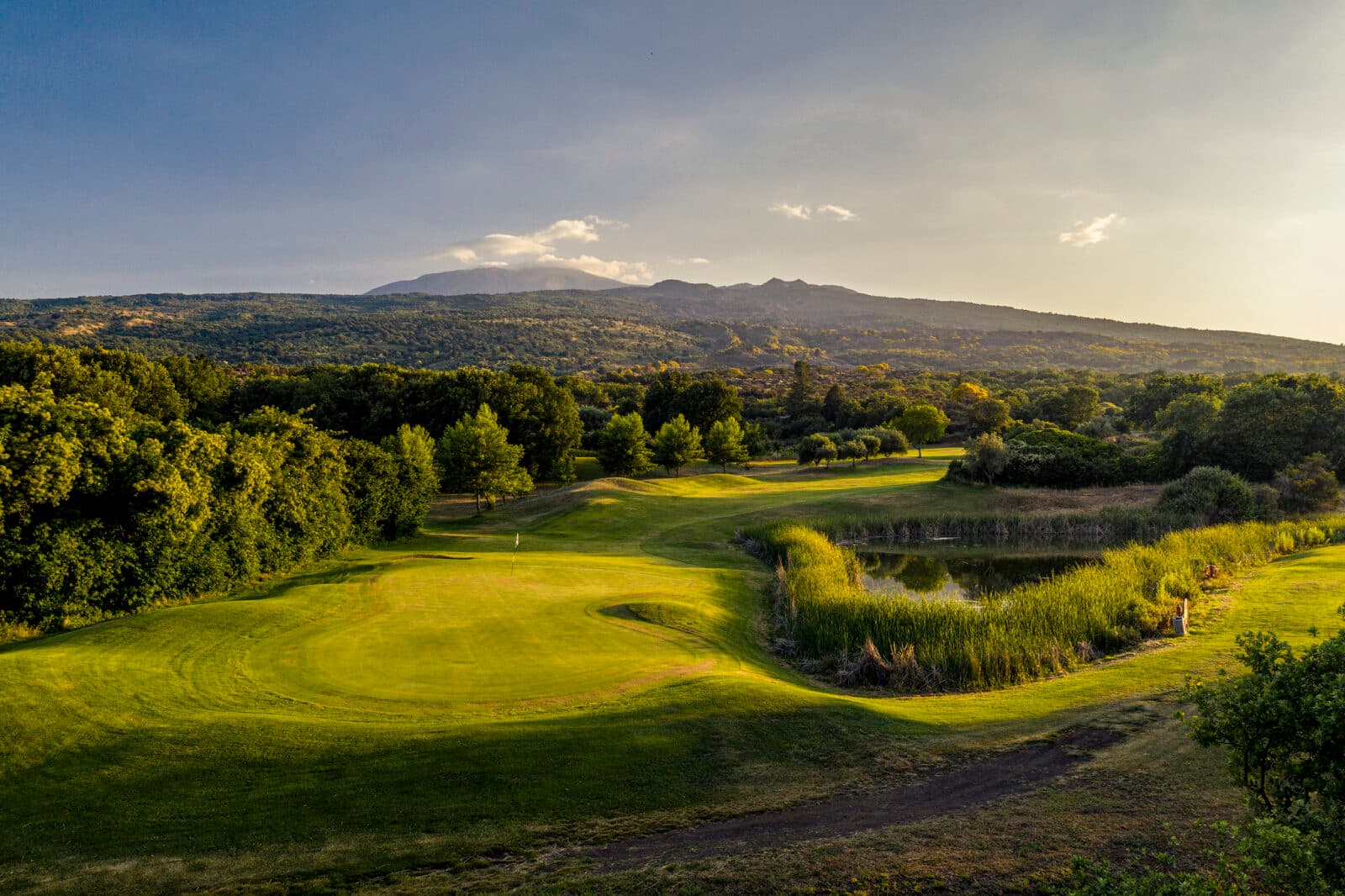 A well maintained fairway leading to a smooth green