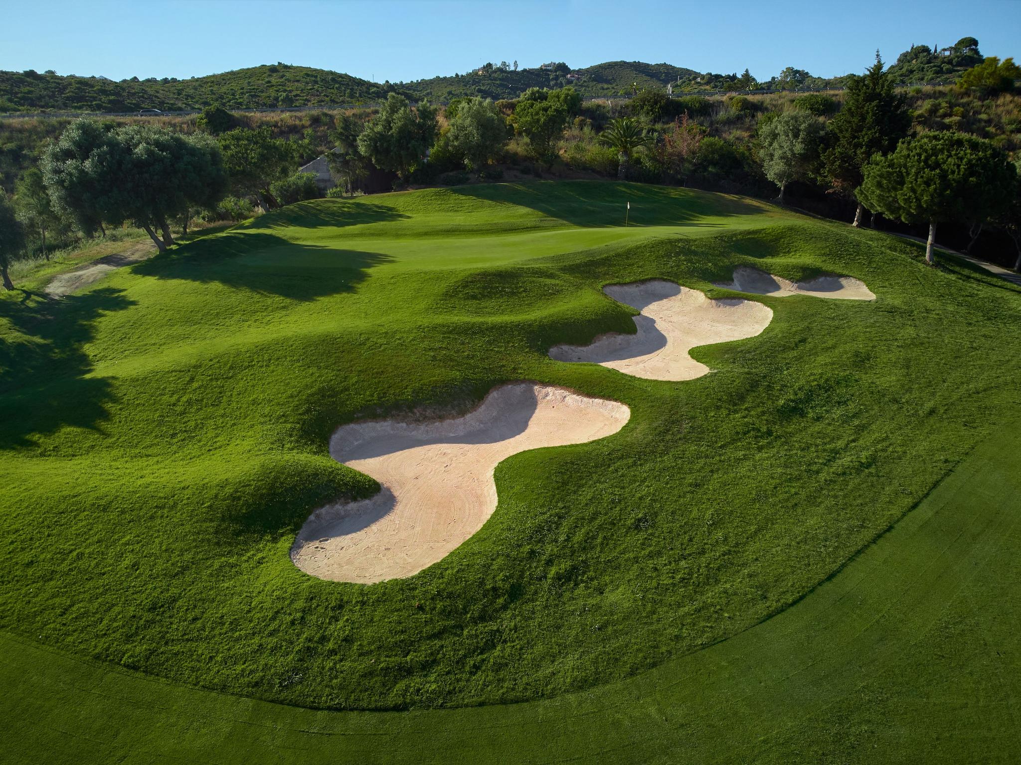 A well maintained fairway nestled with rolling dunes and sand bunkers