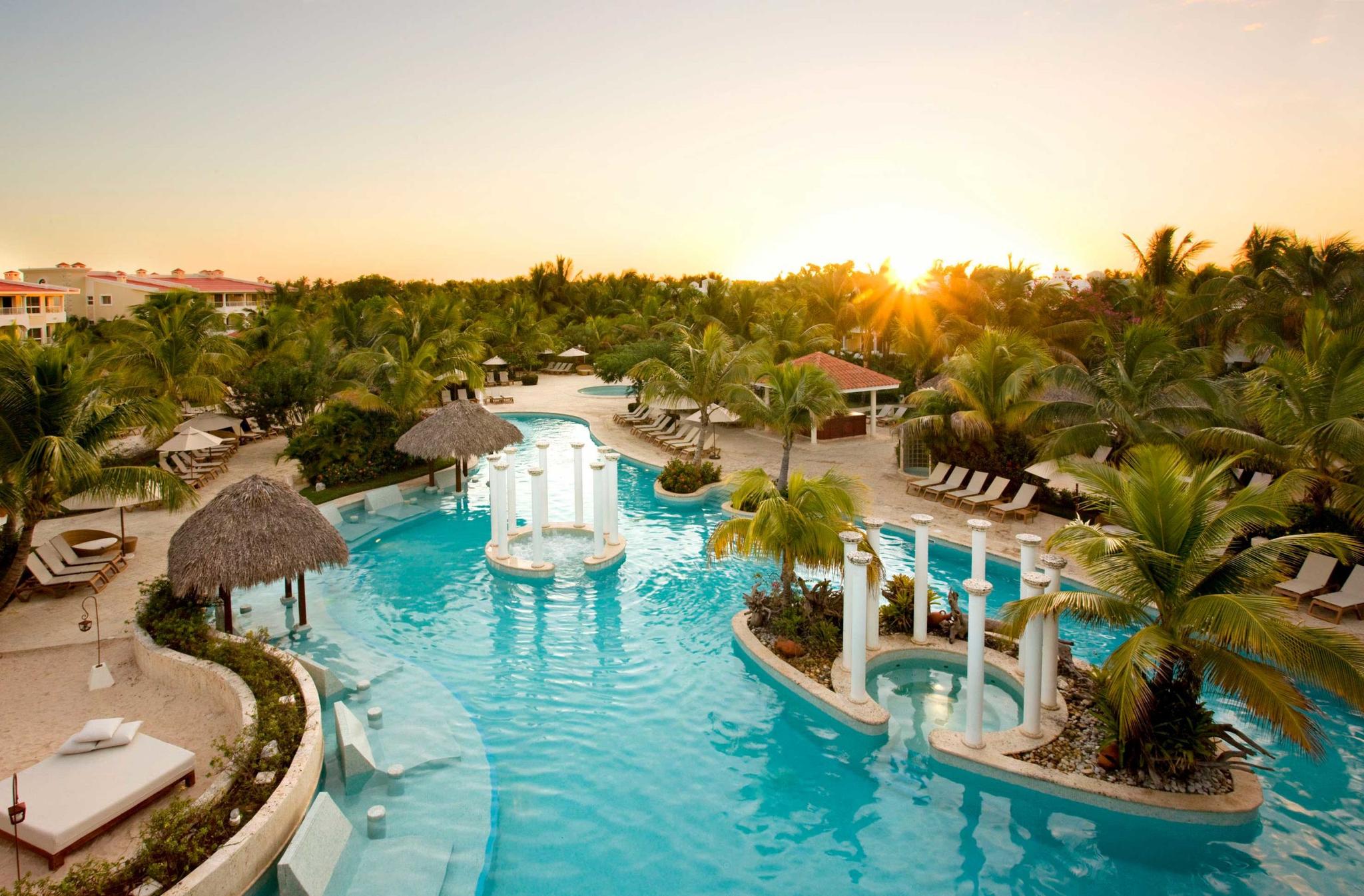 Sun setting over the outdoor swimming pool at Melia Caribe Tropical