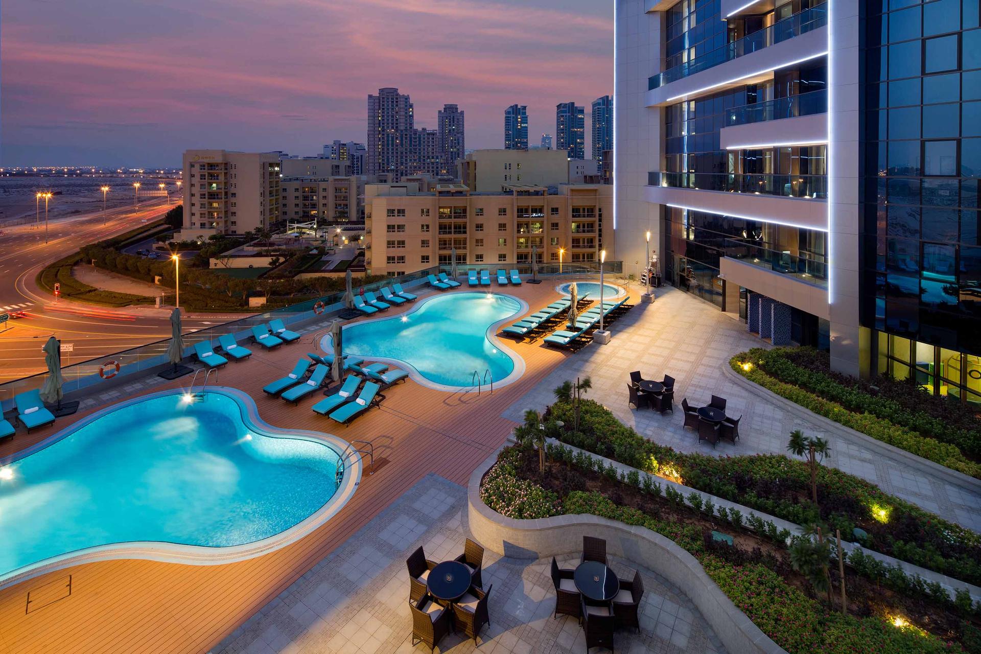 Rooftop swimming at night time Millennium Place Dubai Marina