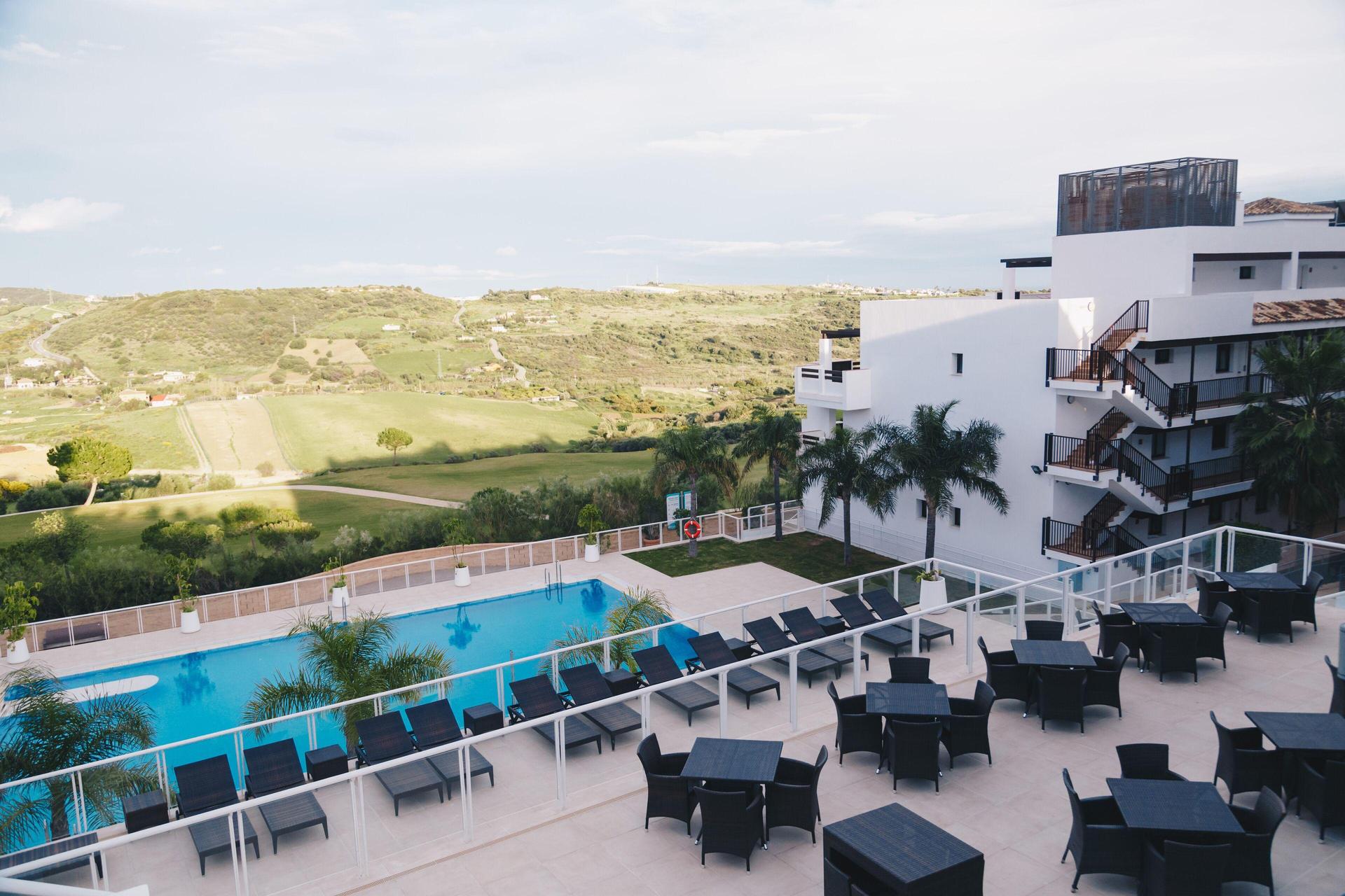 Overhead view of the outdoor pool at ONA Valle Romano Golf Resort