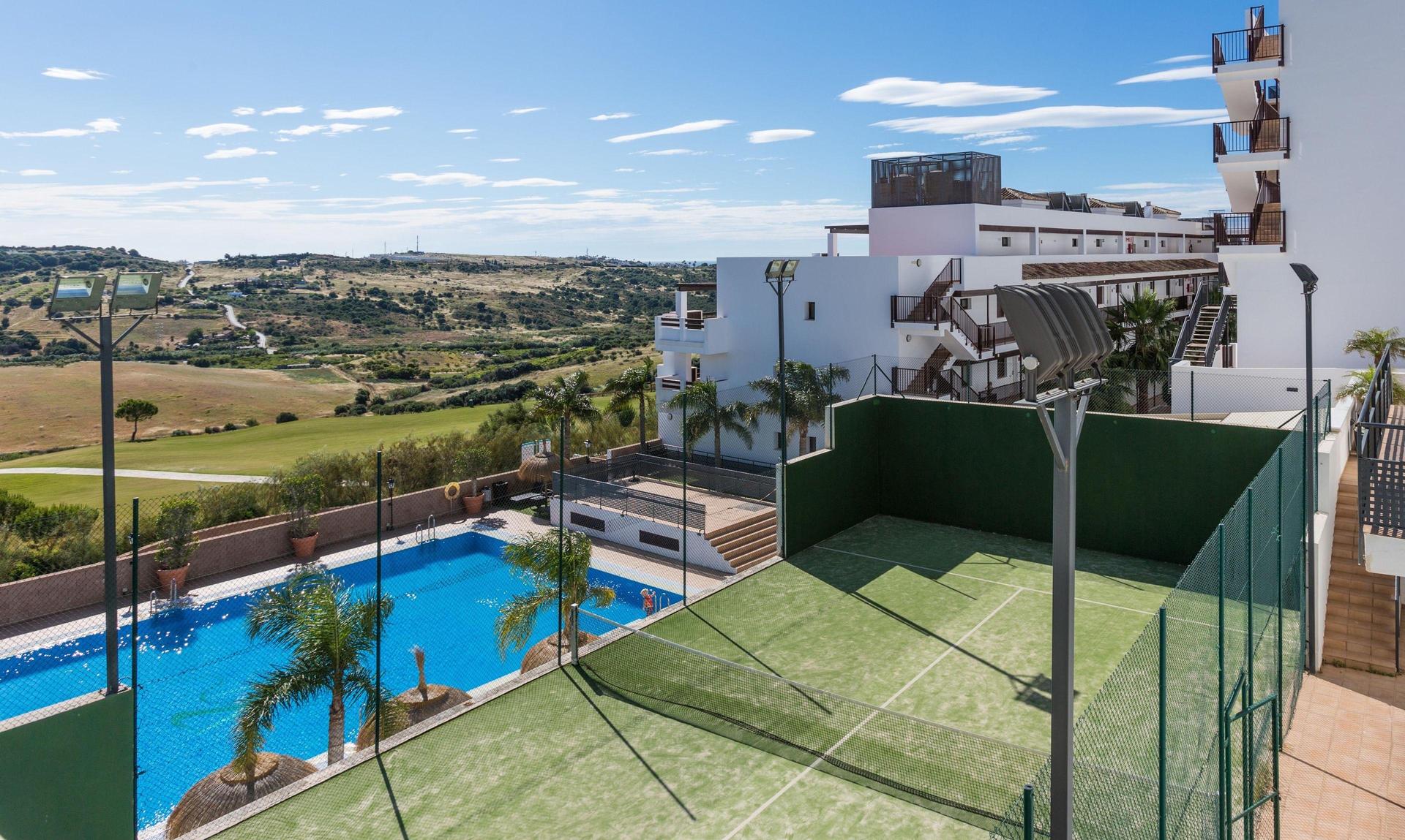 Overhead view of the tennis court and outdoor pool at ONA Valle Romano Golf Resort