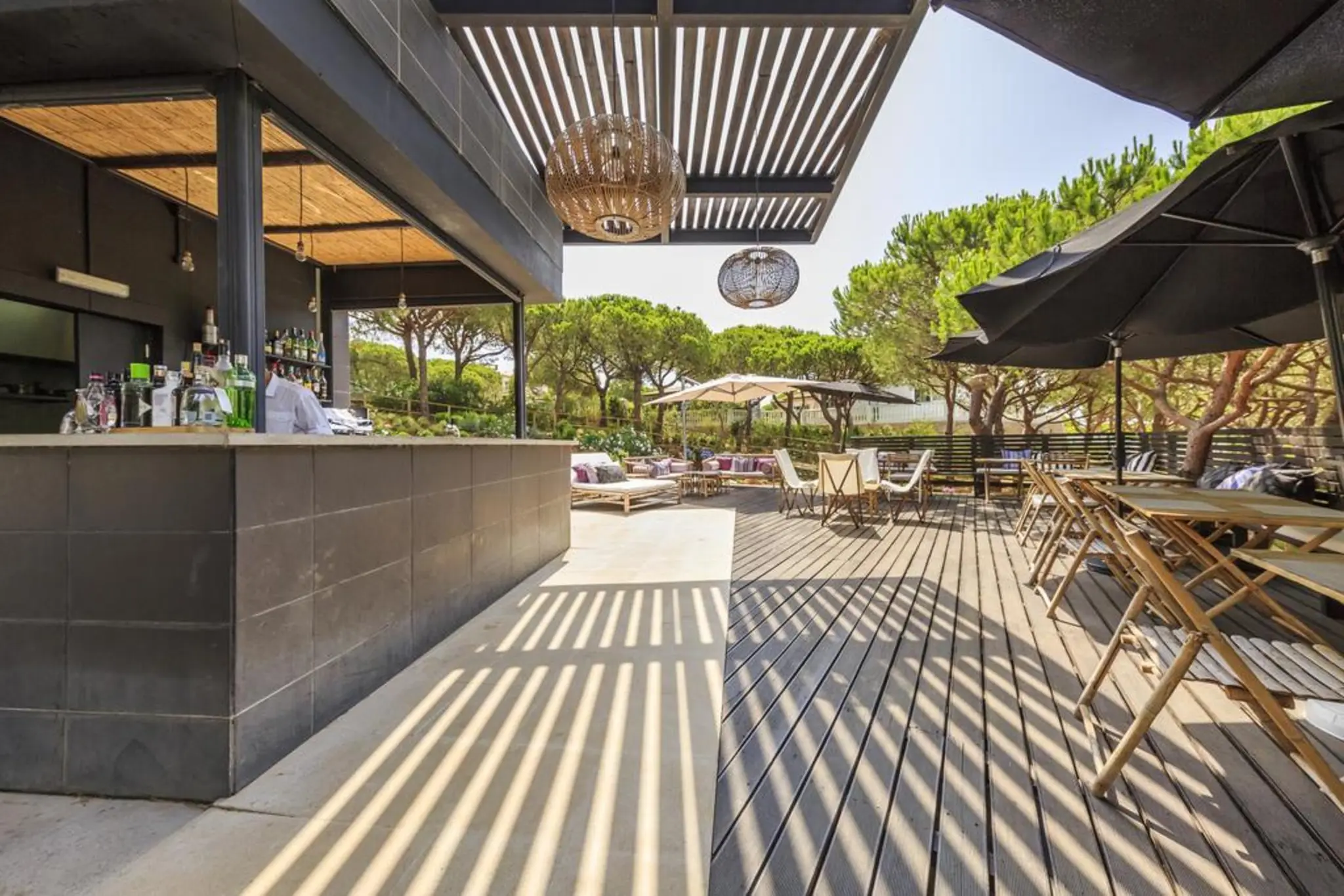 Outdoor bar and lounging area at Octant Hotel Praia Verde