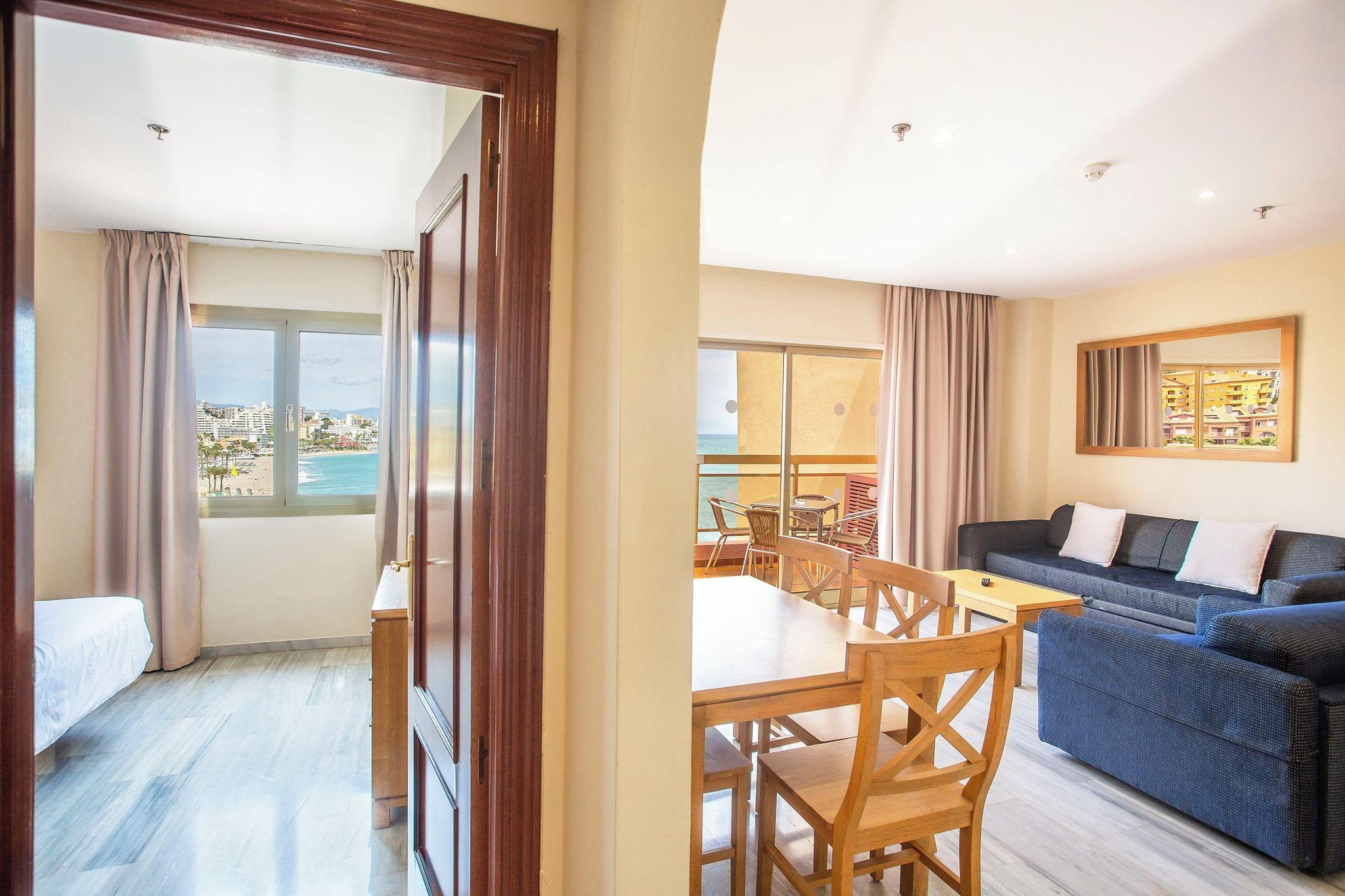 Double bed suite with a separate living room at Sunset Beach Club