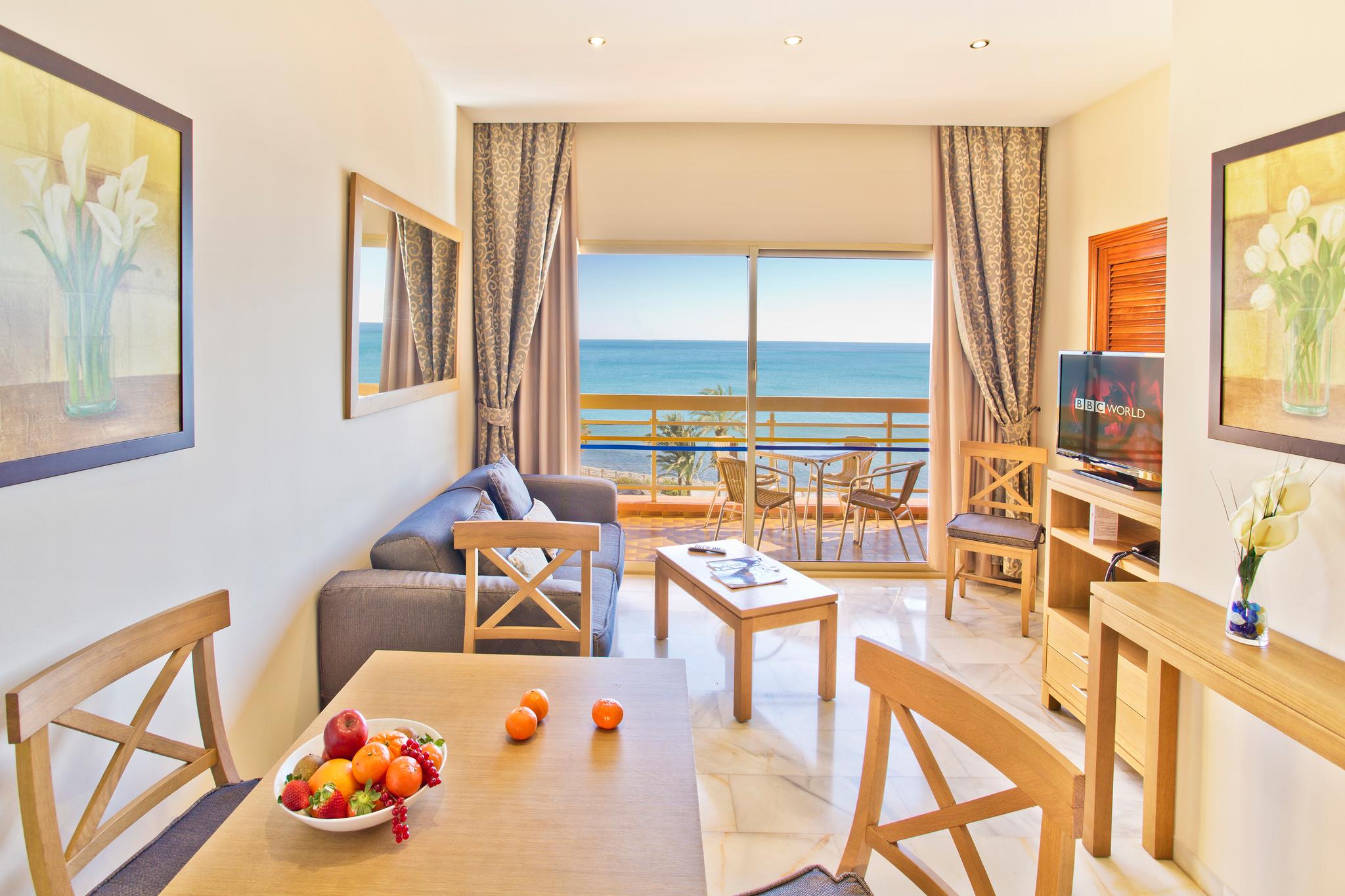 Living room with balcony views at Sunset Beach Club