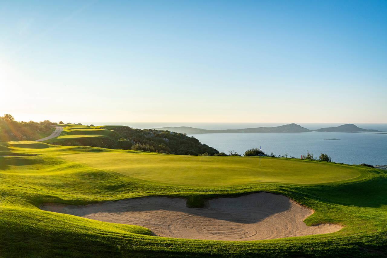 A smooth green next to a sand bunker