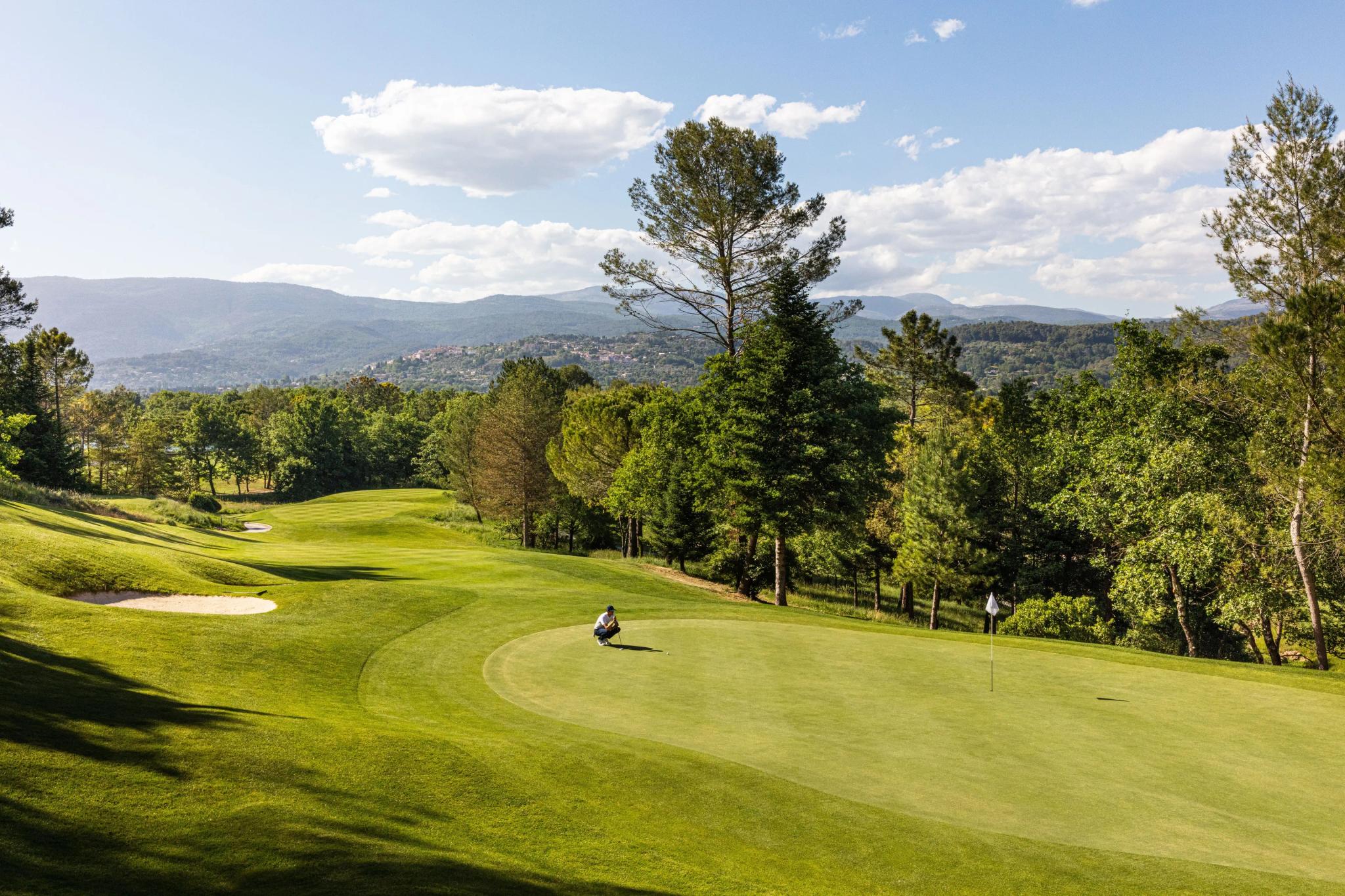 Golfer on a smooth green lining up his shot