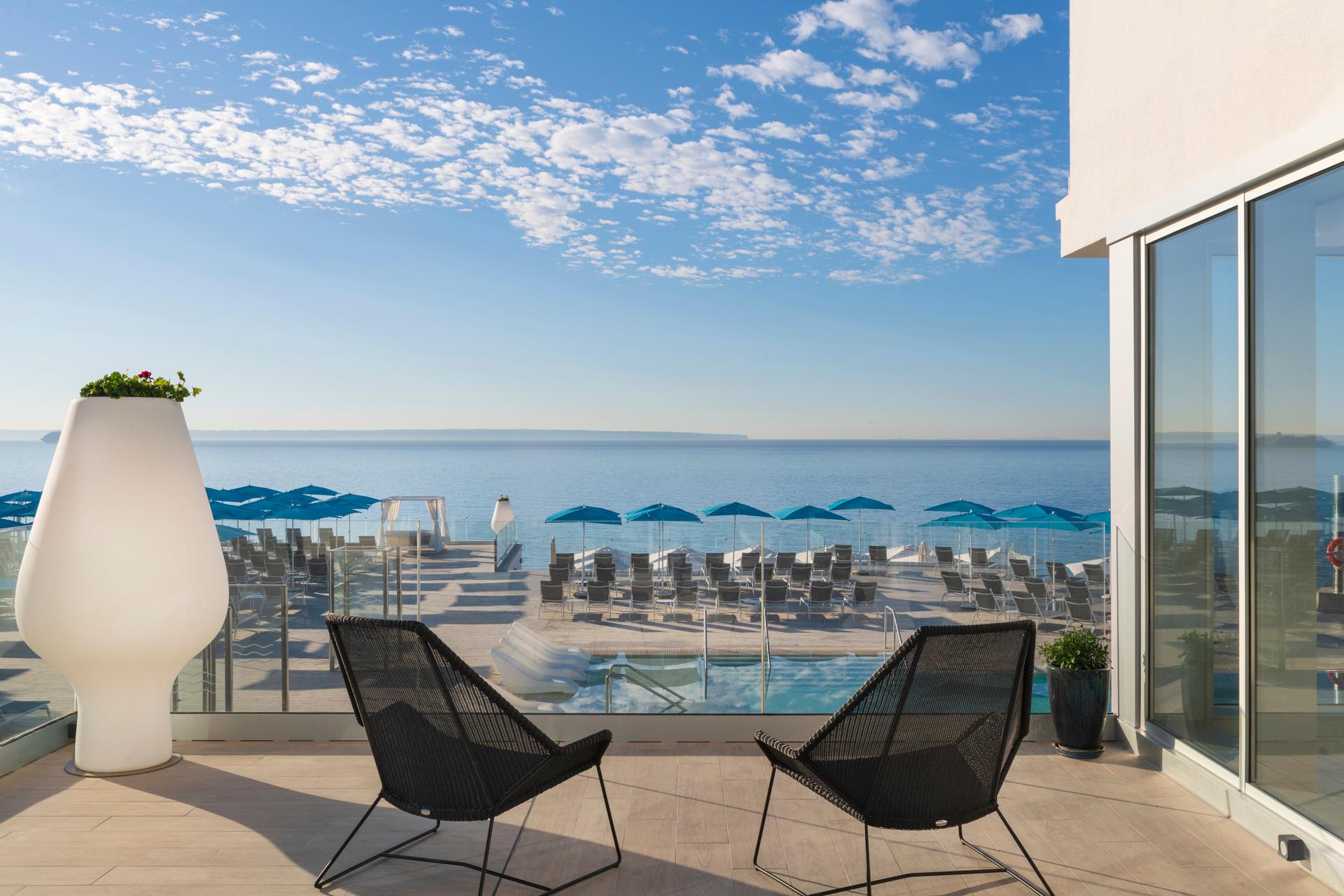 Balcony views overlooking the outdoor pool and coastal views