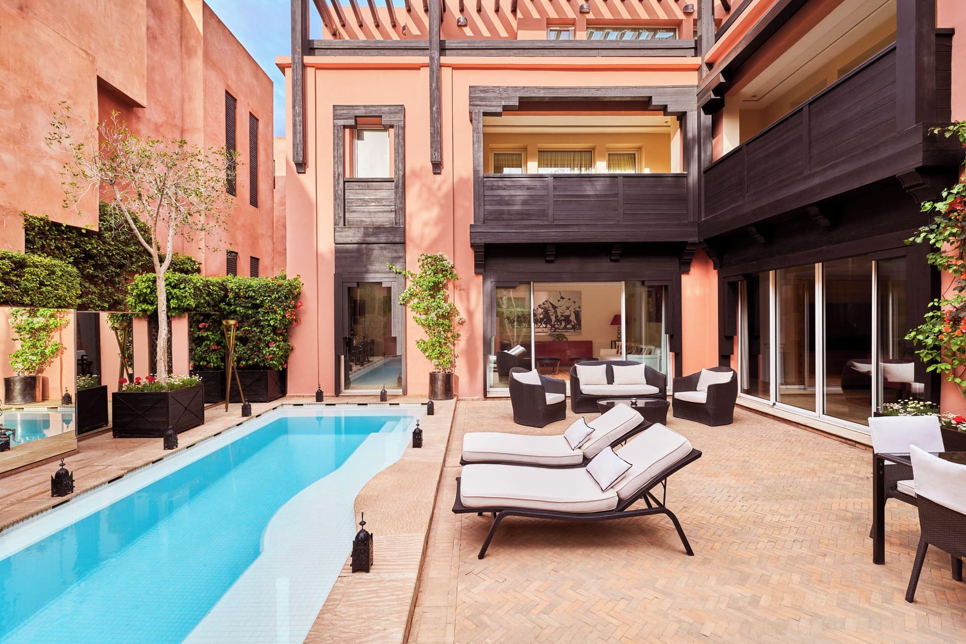Outdoor lounging area and pool as part of a private villa at Hotel & Ryads Barrière Le Naoura