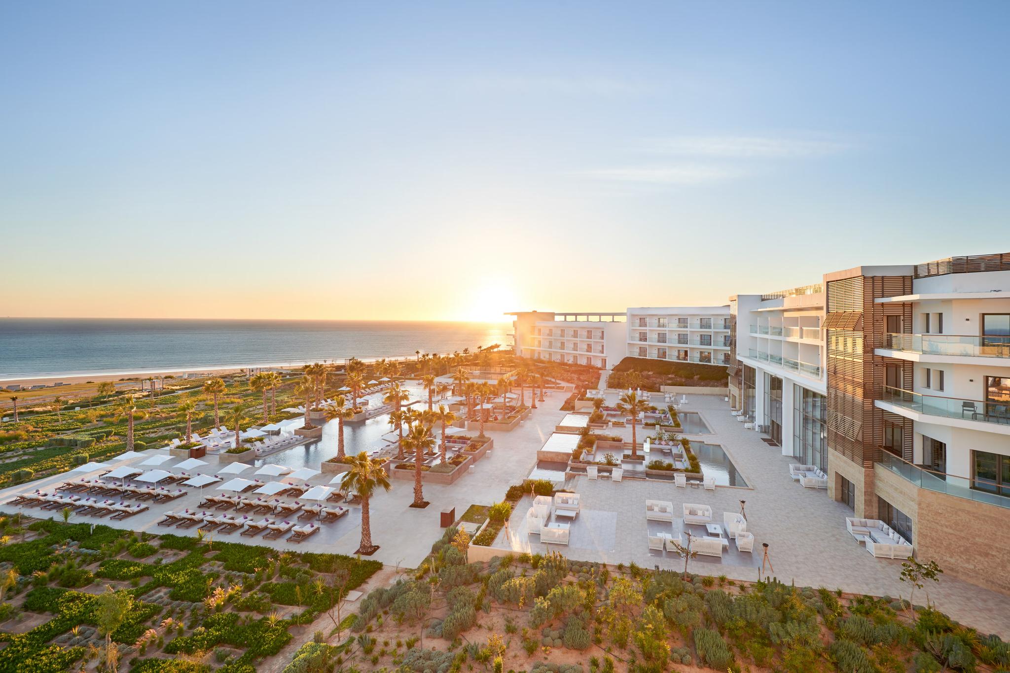 Panoramic view of the sun setting over Hyatt Place Taghazout Bay