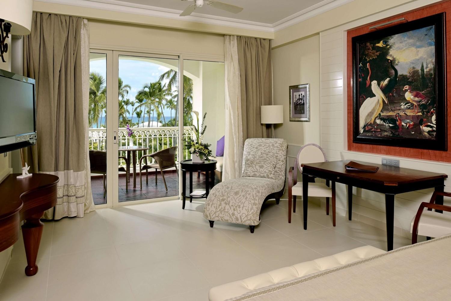 Living room as part of a suite with balcony views