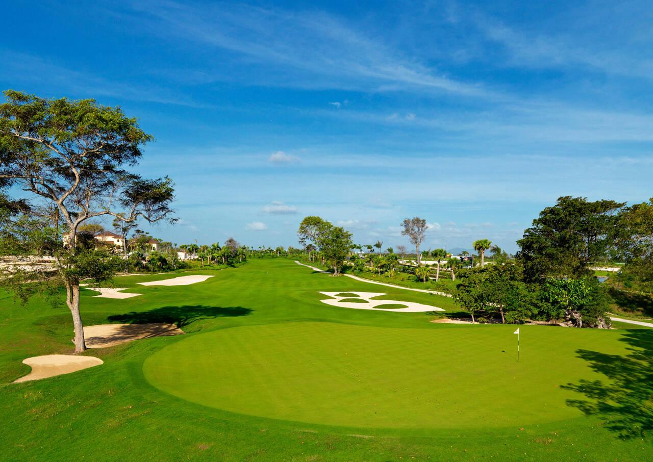 A smooth green at the end of a well maintained fairway