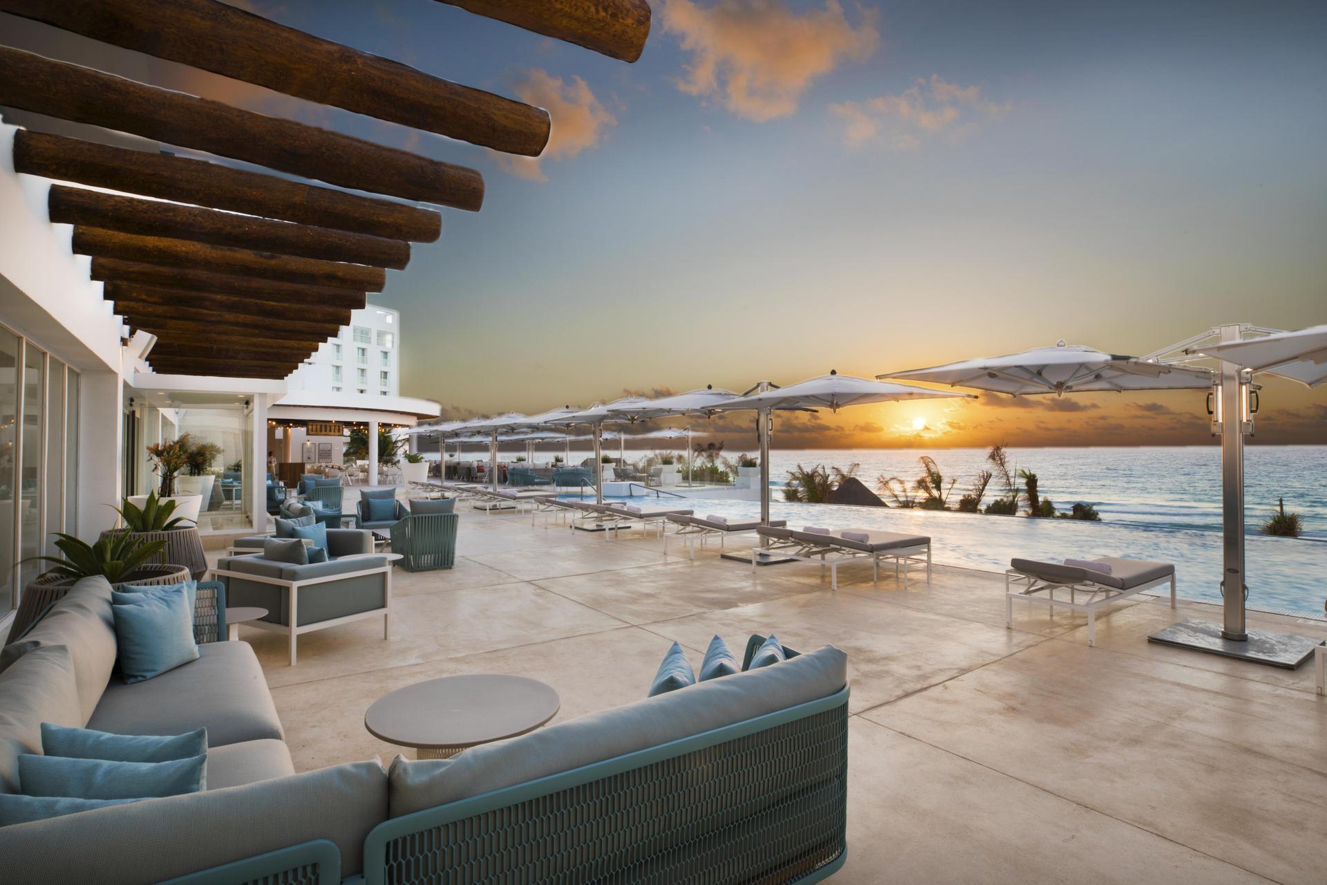 Outdoor lounging area with ocean views at sunset