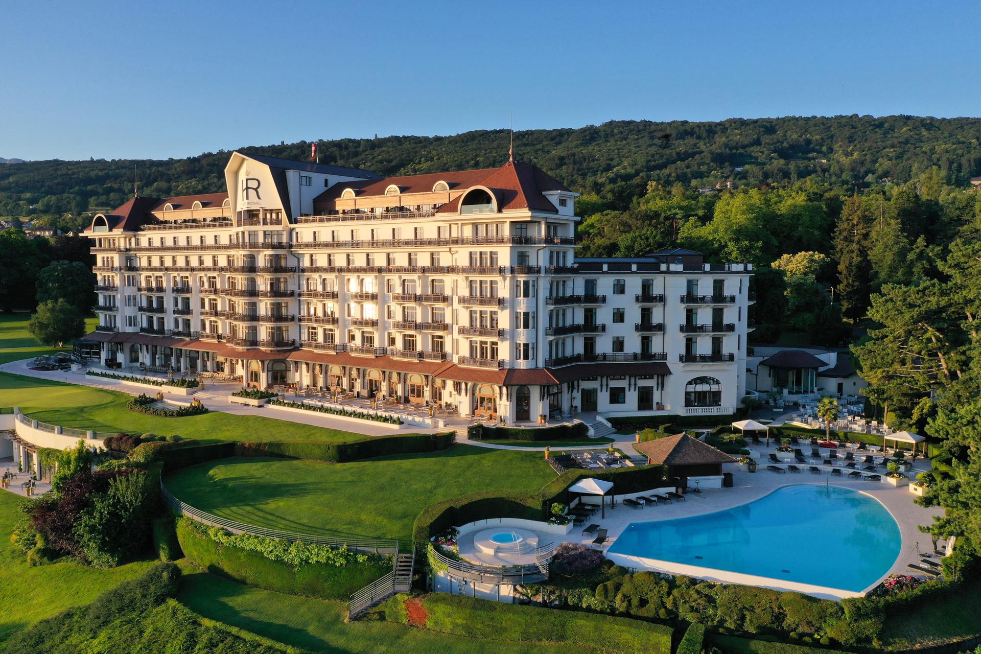 Panoramic view of Hotel Royal Evian Resort overlooking its outdoor pool