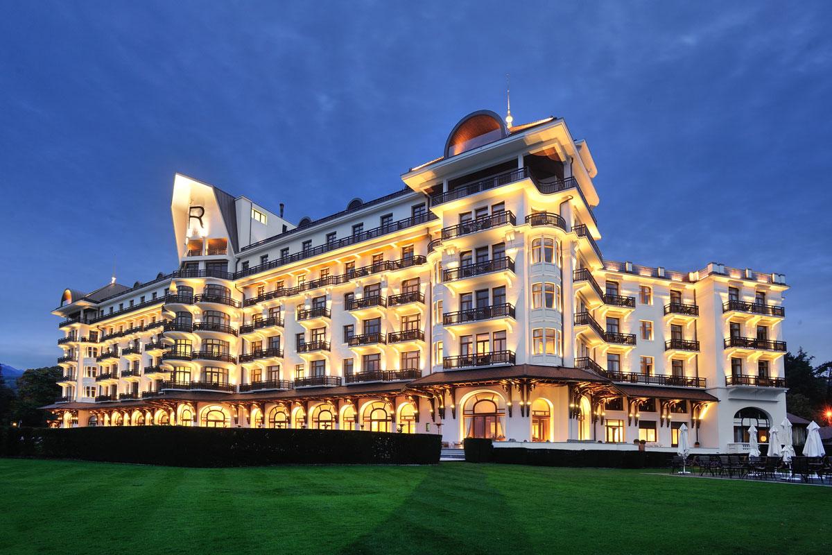 Panoramic view of Hotel Royal Evian Resort lit up at evening