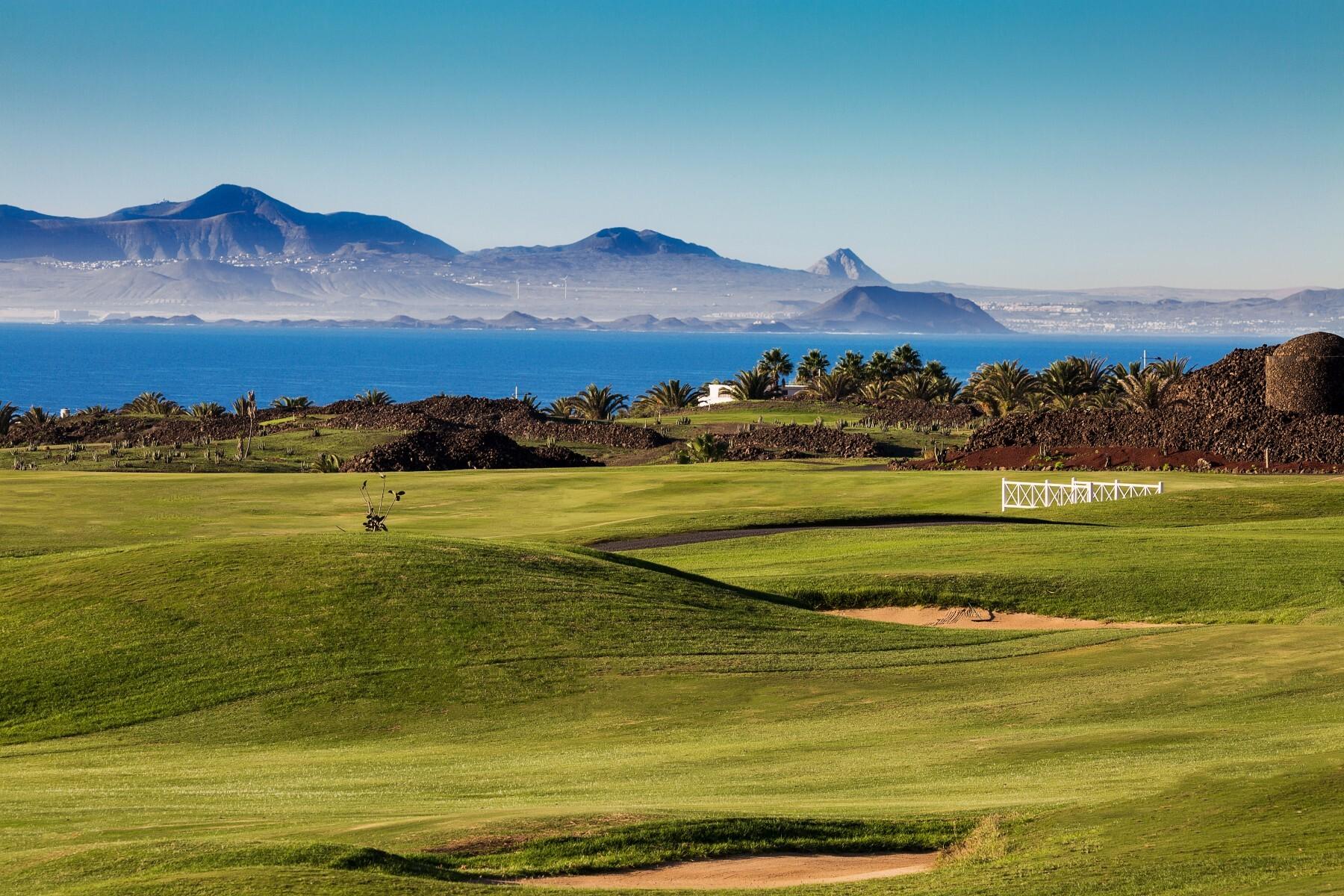 A well maintained fairway nestled with sand bunkers and rolling dunes