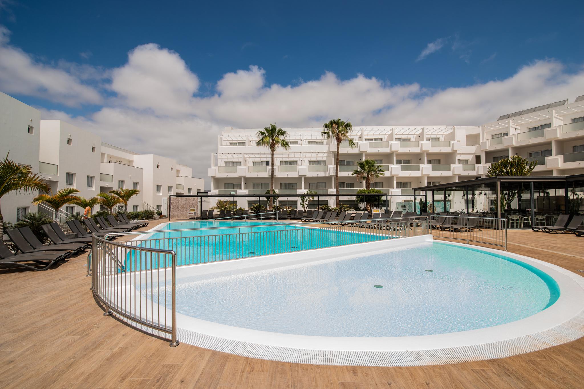 Panoramic view of an outdoor swimming pool at Aequora Lanzarote Suites