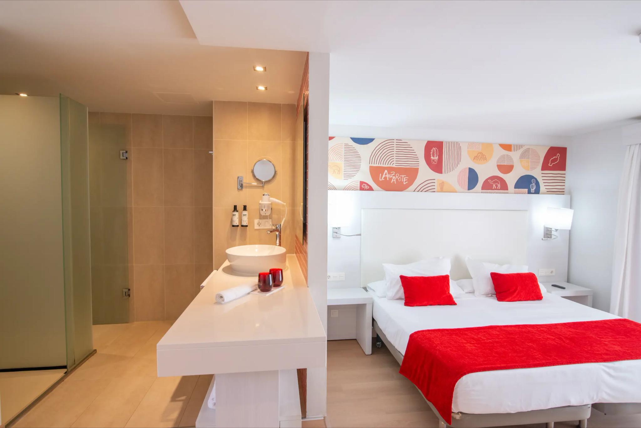 A double bed suite with an open plan bathroom at Aequora Lanzarote Suites