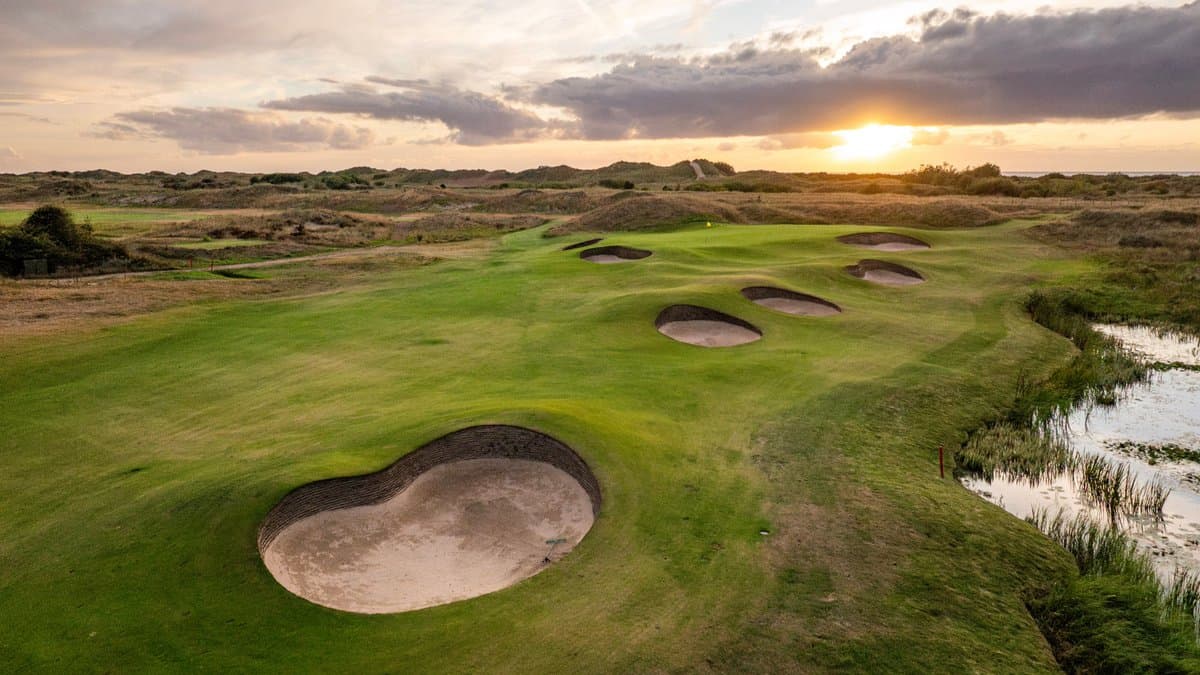 A well maintained fairway nestled with sand bunkers