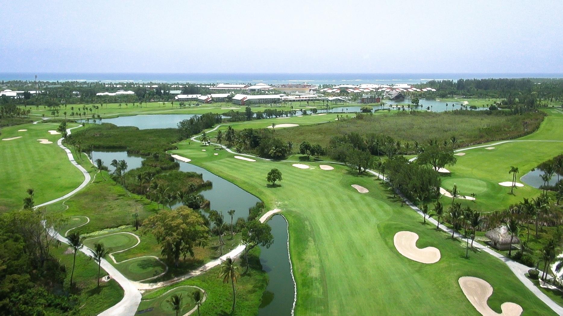 A well maintained fairway nestled with sand bunkers