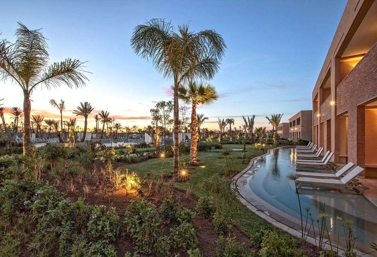 Outdoor swimming pool with sunbeds at the Be Live Collection