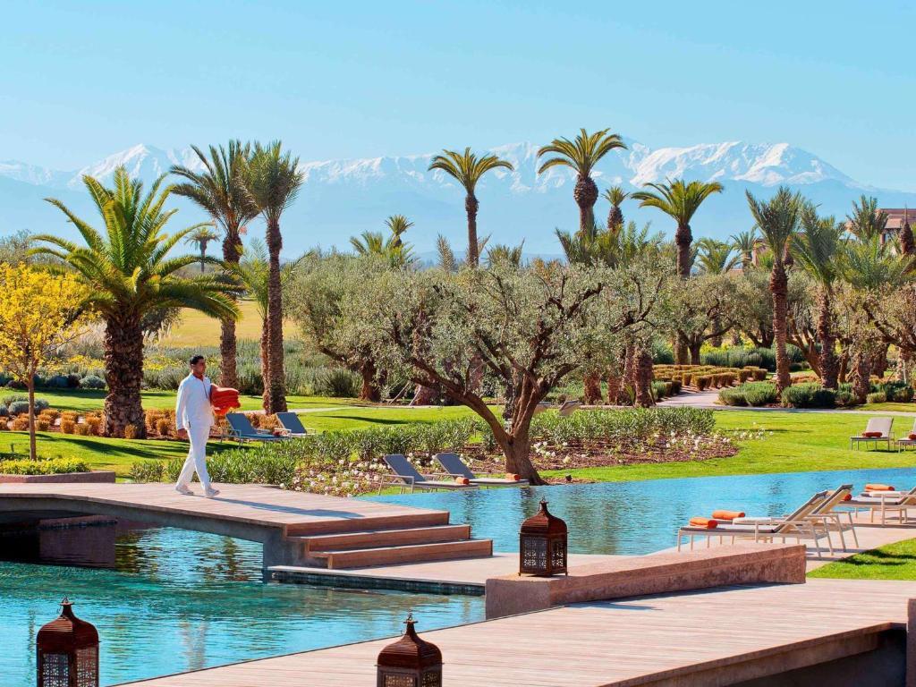 Bridge to navigate an outdoor swimming pool at Fairmont Royal Palm Marrakech