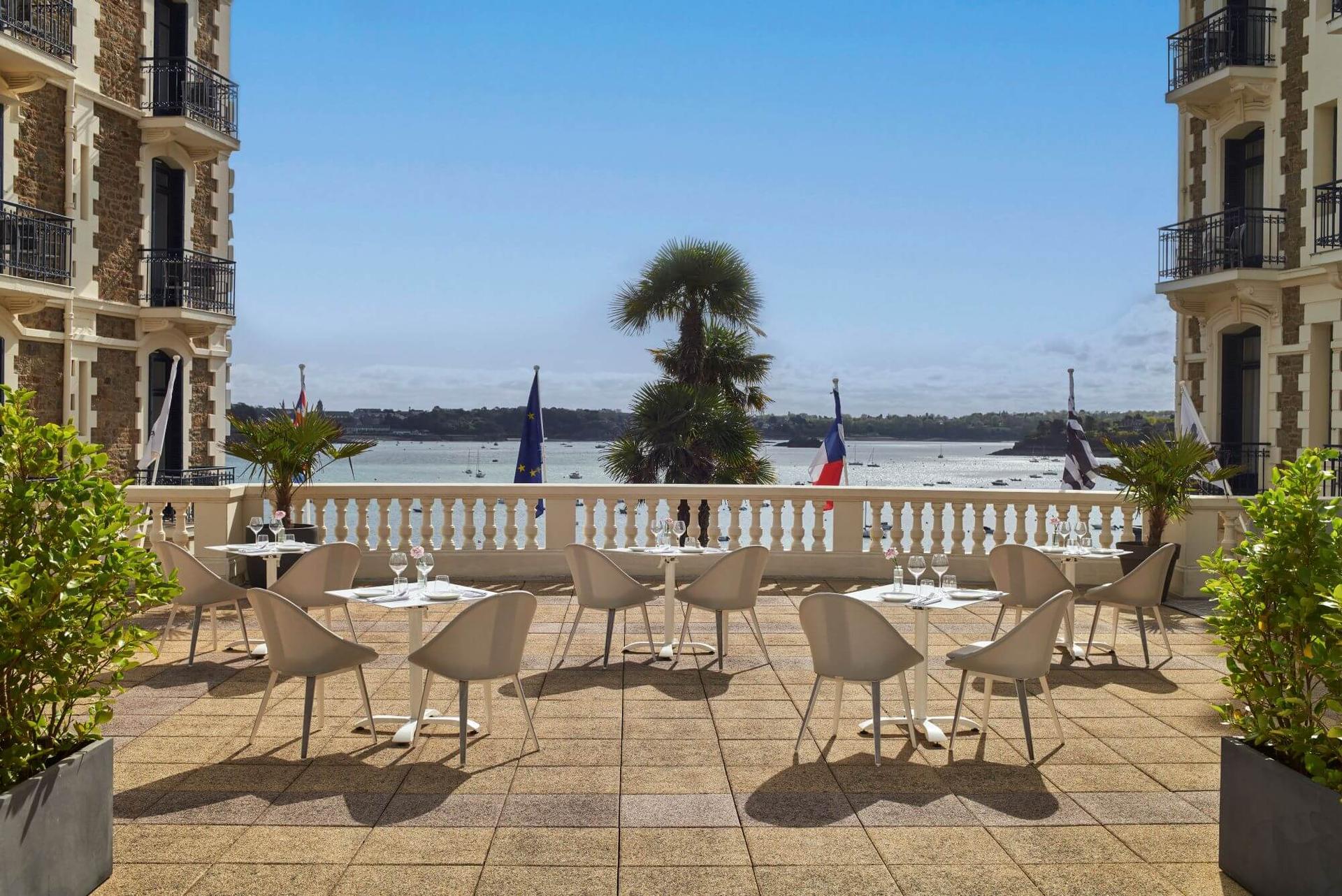 Outdoor lounging with ocean views at Hotel Barriere Le Grand Hotel Dinard