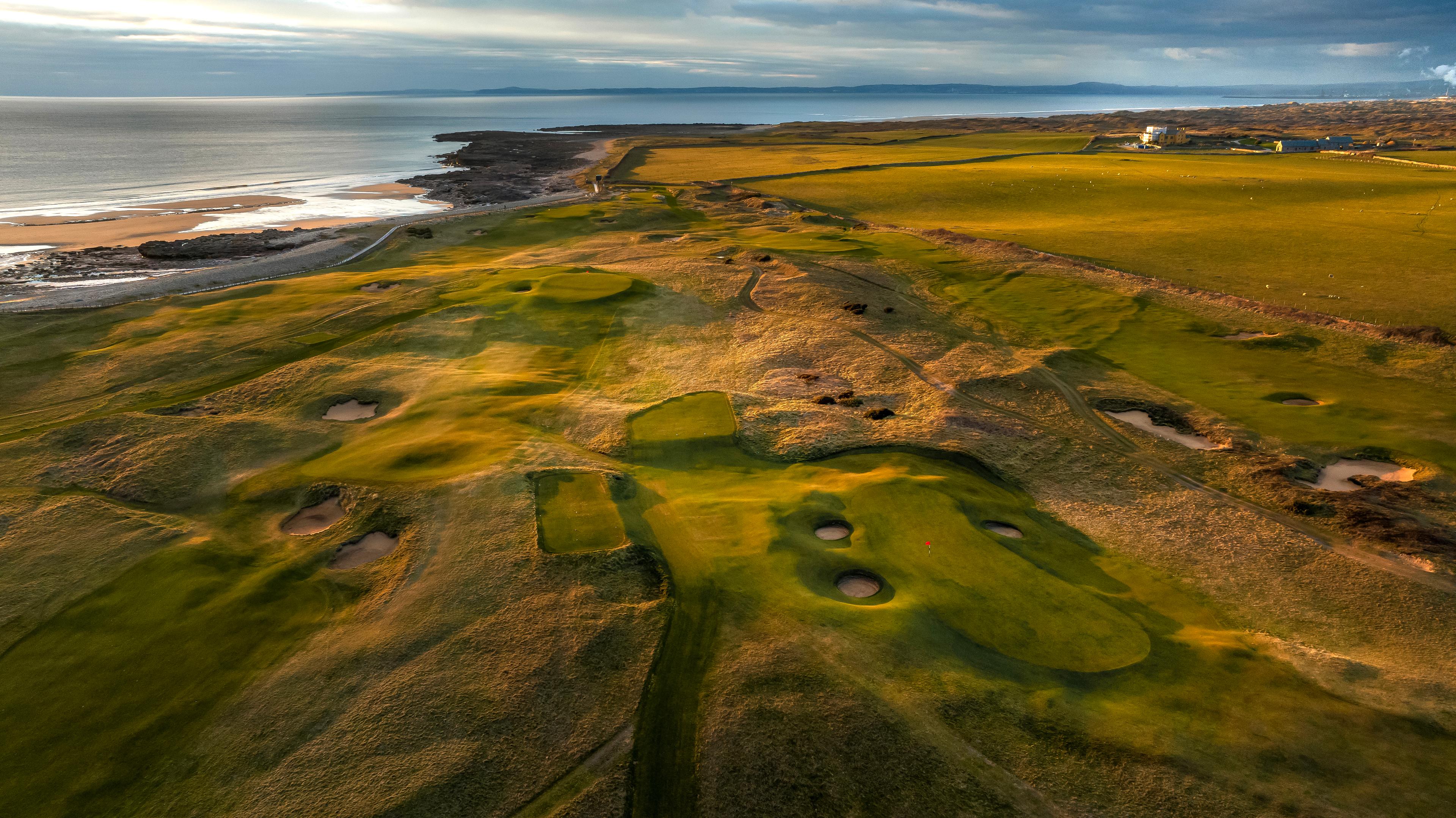 Overhead view of aa well maintained fairway littered with sand bunkers