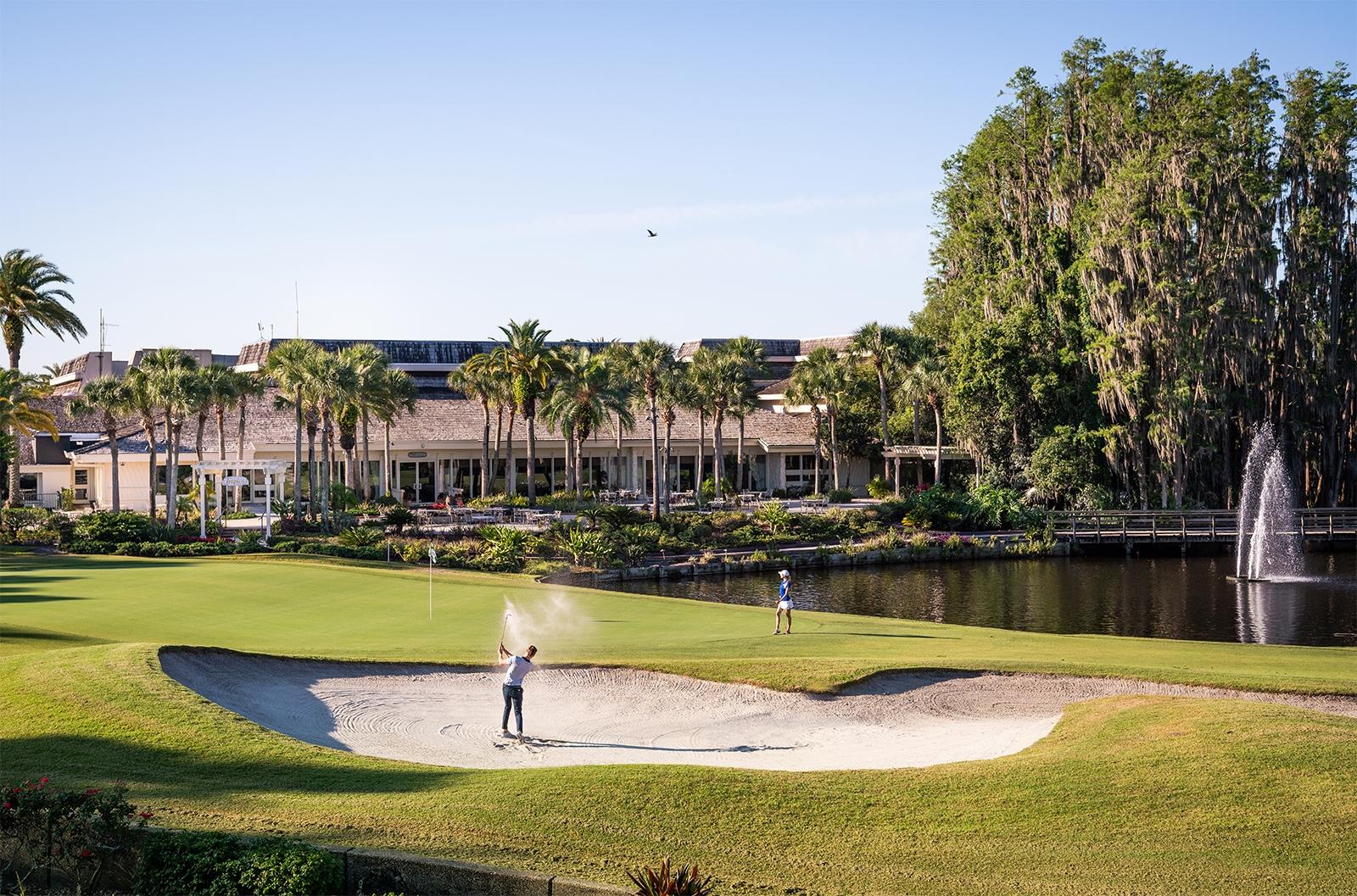 Golfer swinging out of a sand bunker at the Saddlebrook Resort