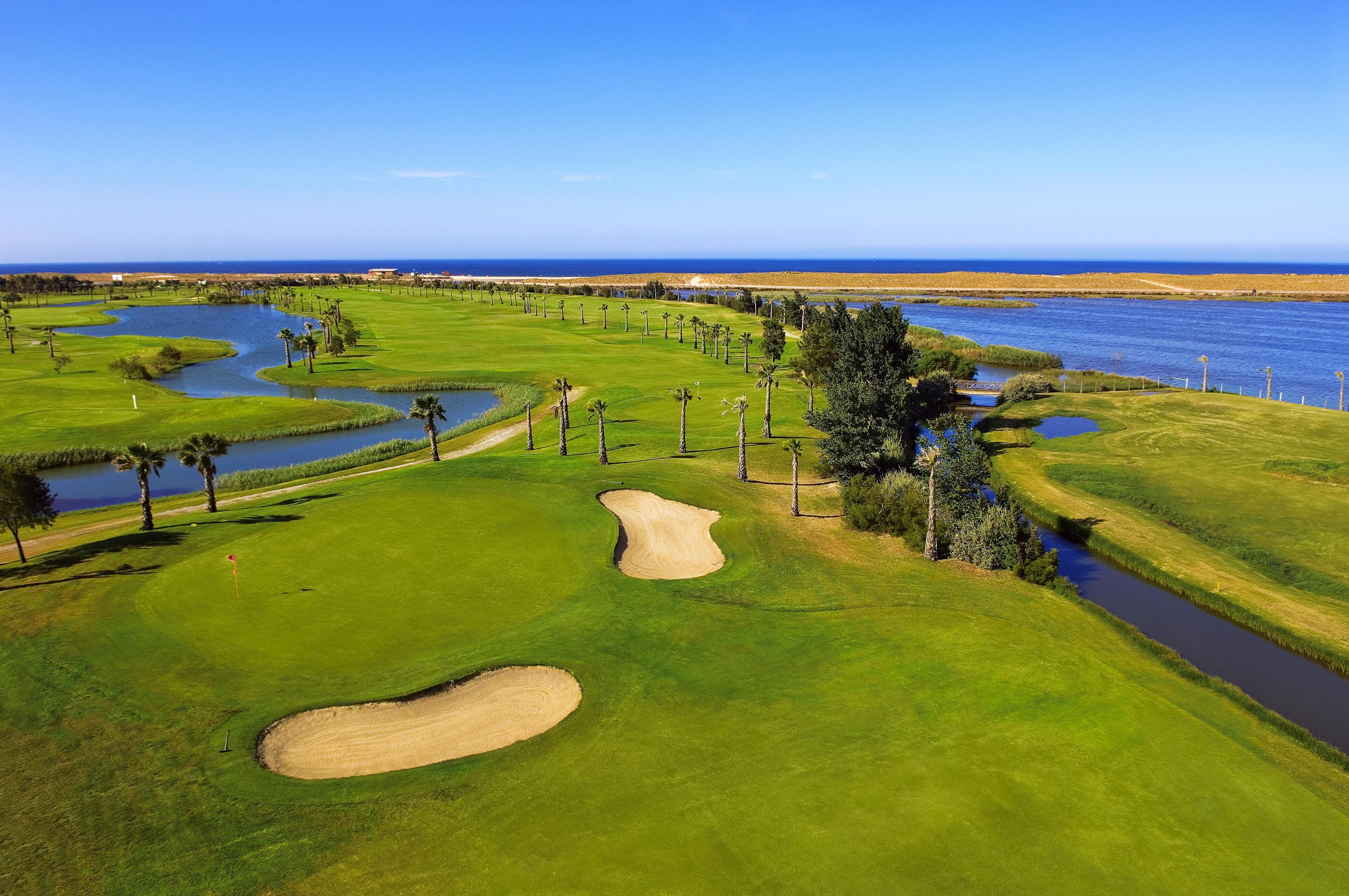 Overhead view of a smooth green surrounded by sand bunkers