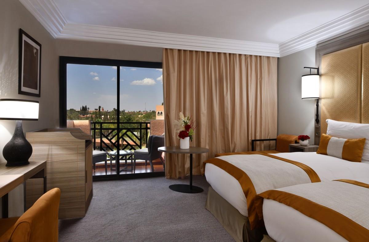 Double bed room at the Movenpick Mansour Eddahbi Hotel with balcony views