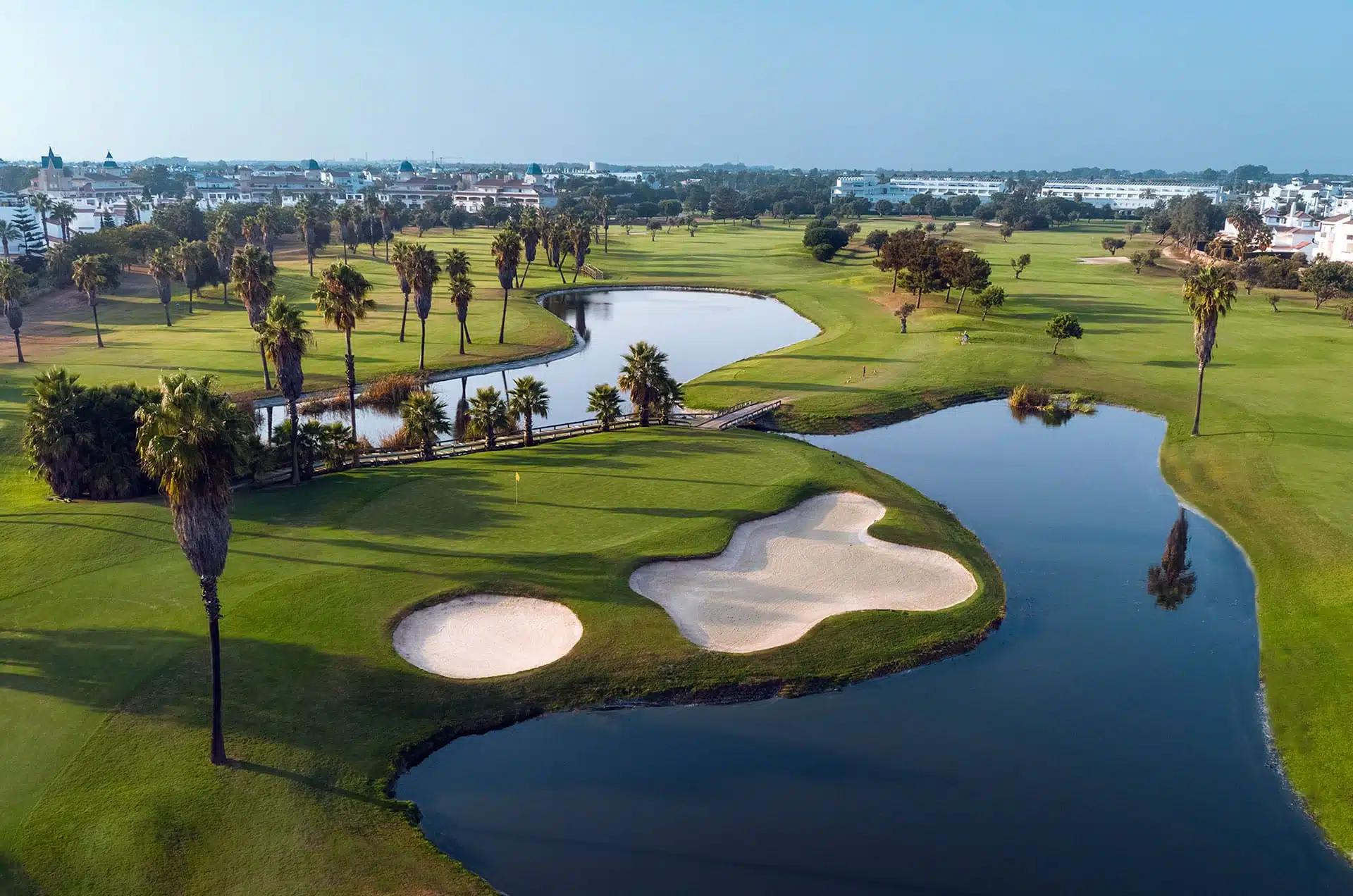 A smooth green next to sand bunkers sandwiched by two water hazards