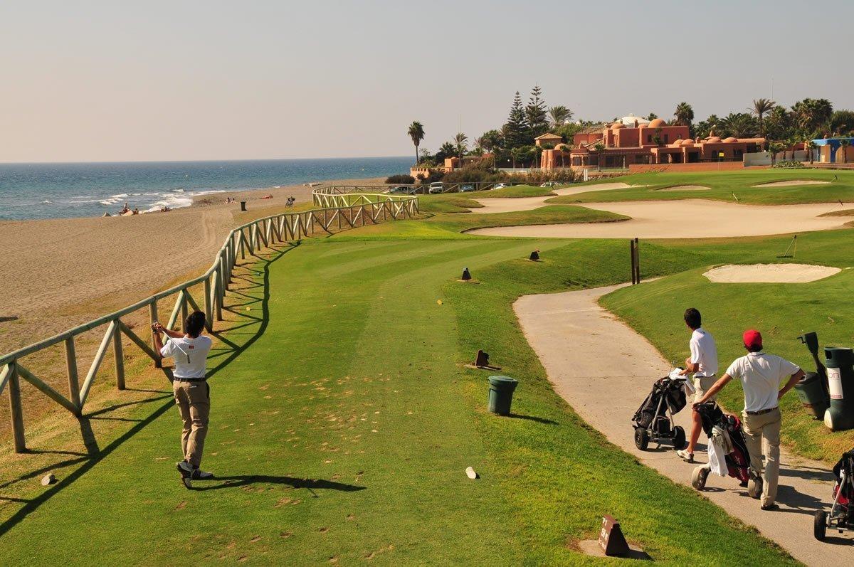 A well maintained fairway nestled with sand bunkers
