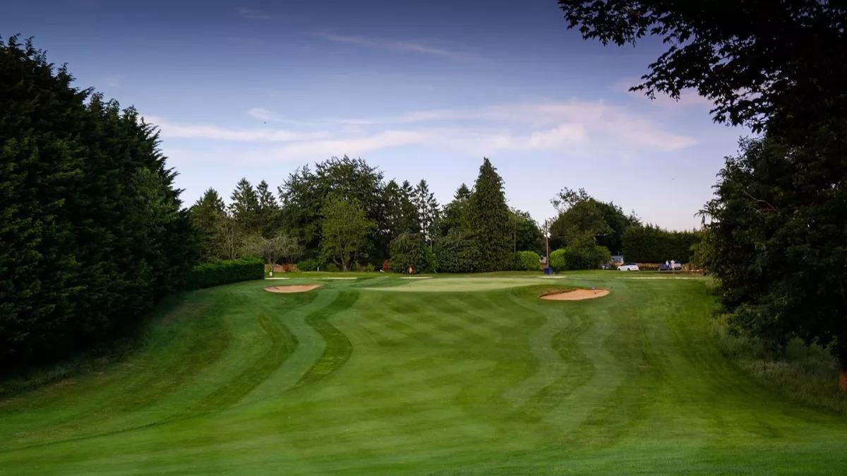 A well maintained fairway nestled with sand bunkers at Cotswolds Golf Hotel and Spa