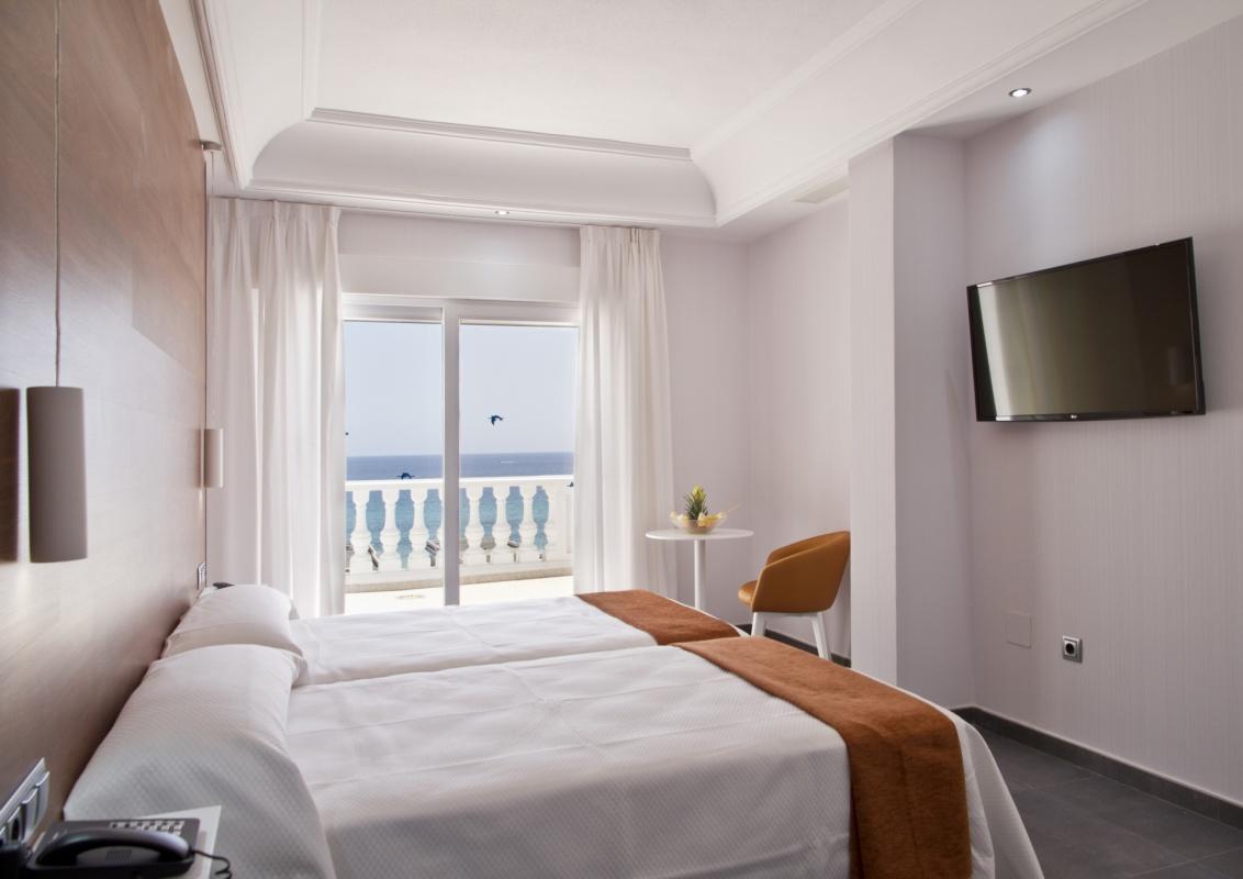Double bed suite with balcony views at Delfines Hotel & Suites