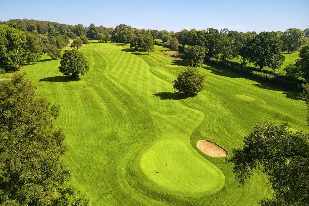 Overhead view of a well maintained fairway leading to a smooth green