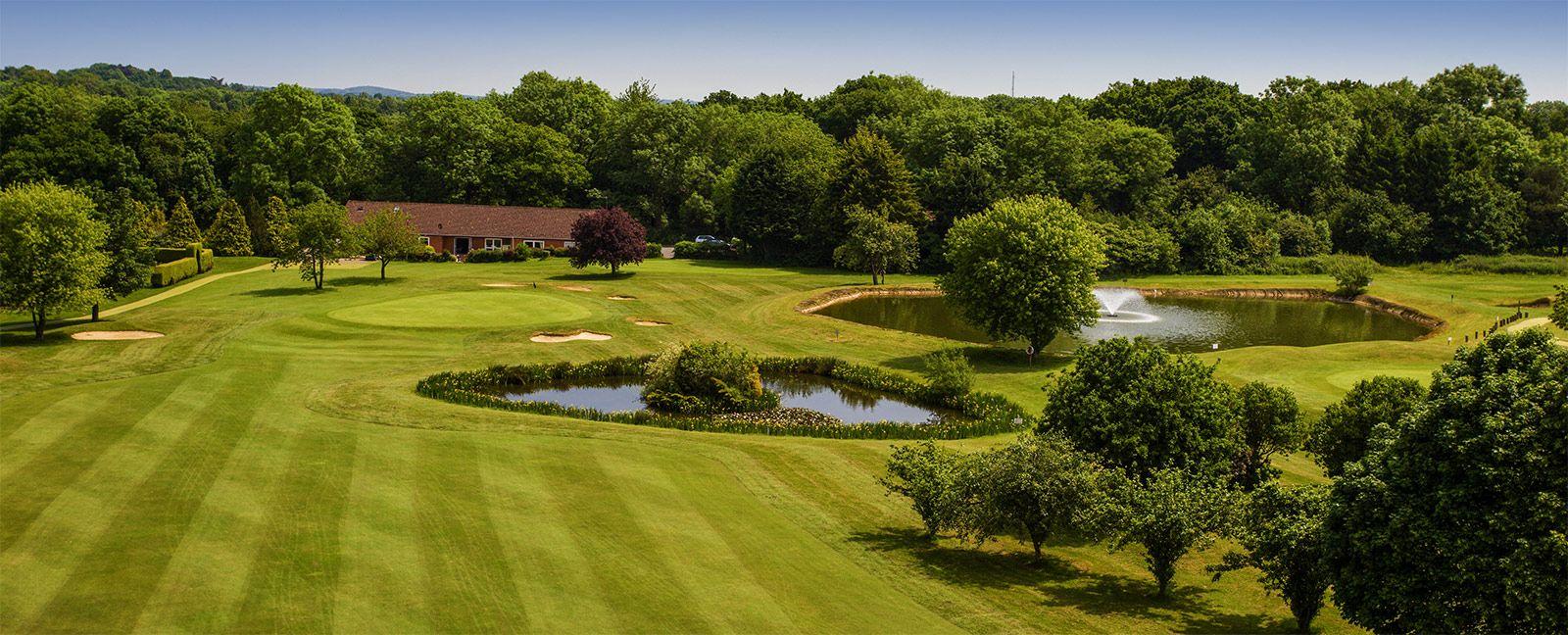 Overhead view of a fairway with a water hazard