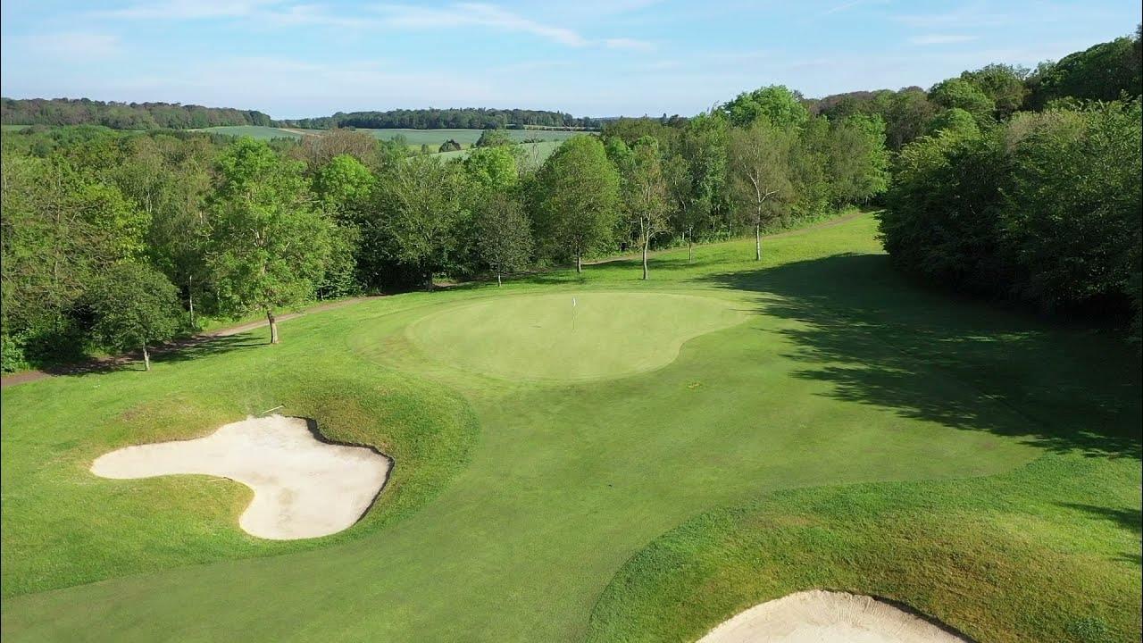 Overhead view of a well maintained fairway nestled with sand bunkers