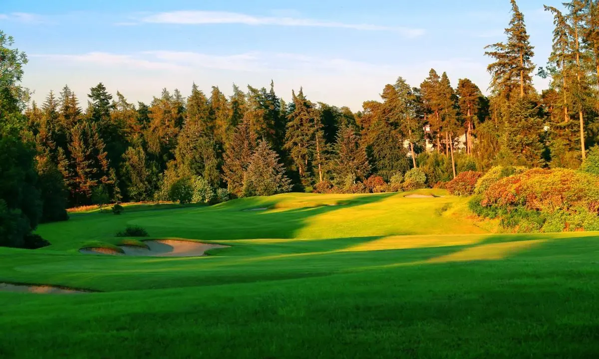 A wide fairway nestled with sand bunker