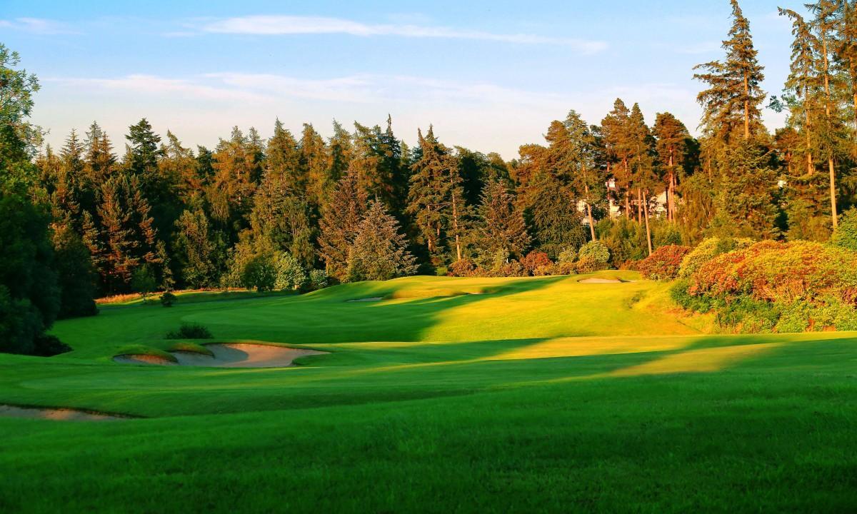 A wide fairway nestled with sand bunker