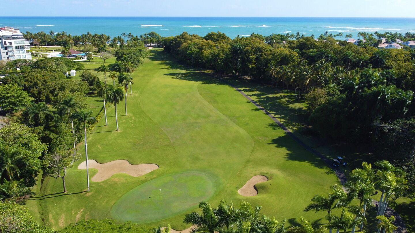 A well maintained fairway nestled with sand bunkers