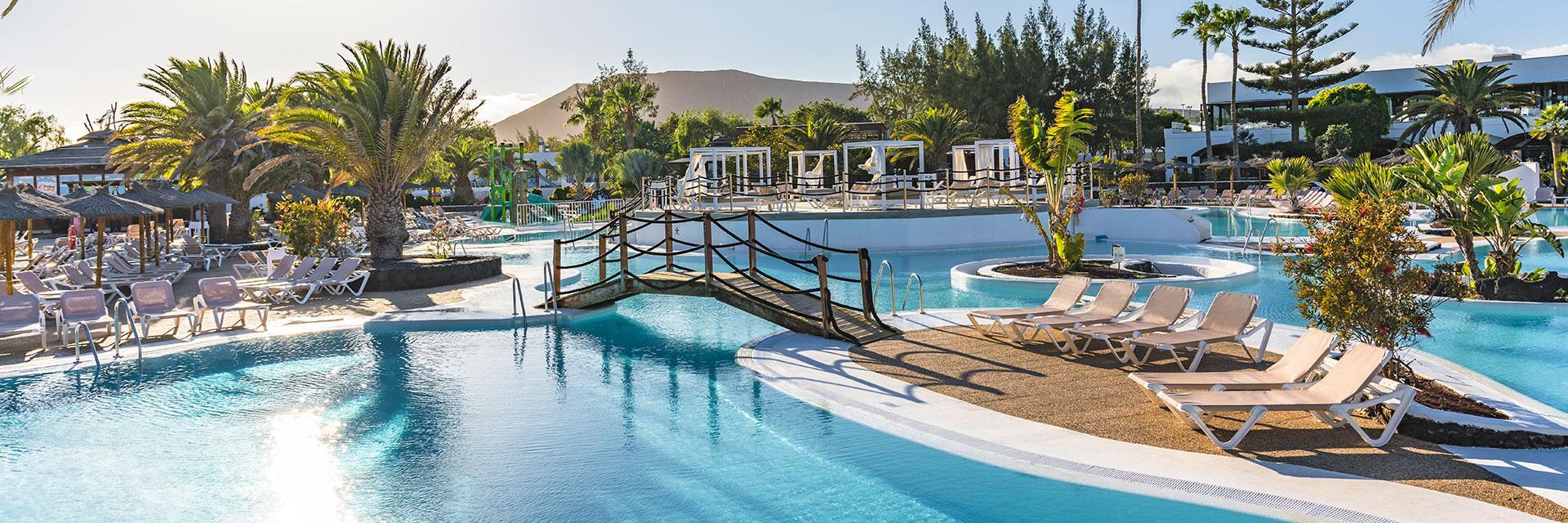 A bridge to navigate the outdoor pool at Elba Lanzarote Royal Village Resort